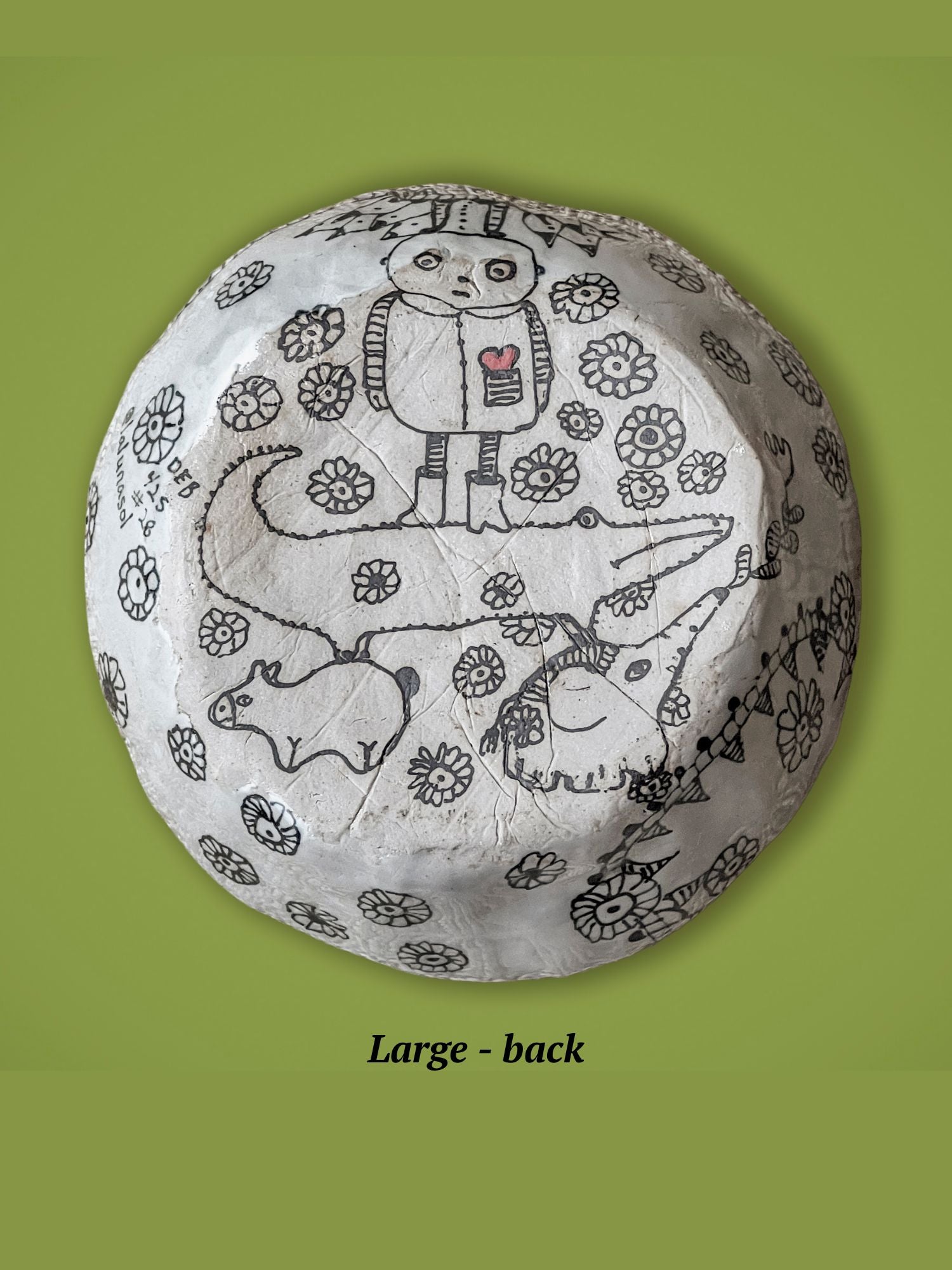 Round ceramic bowl with animal drawings on a green background. This is the backside of the previous bowl. It has a small man standing on a crocodile. The surface is matte, not glossy.
