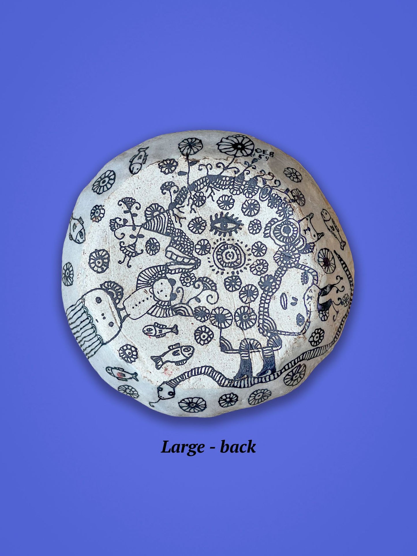 This is the backside of the previous piece. It is a matte surface as compared to glossy on the other side. It has similar intricate black designs.