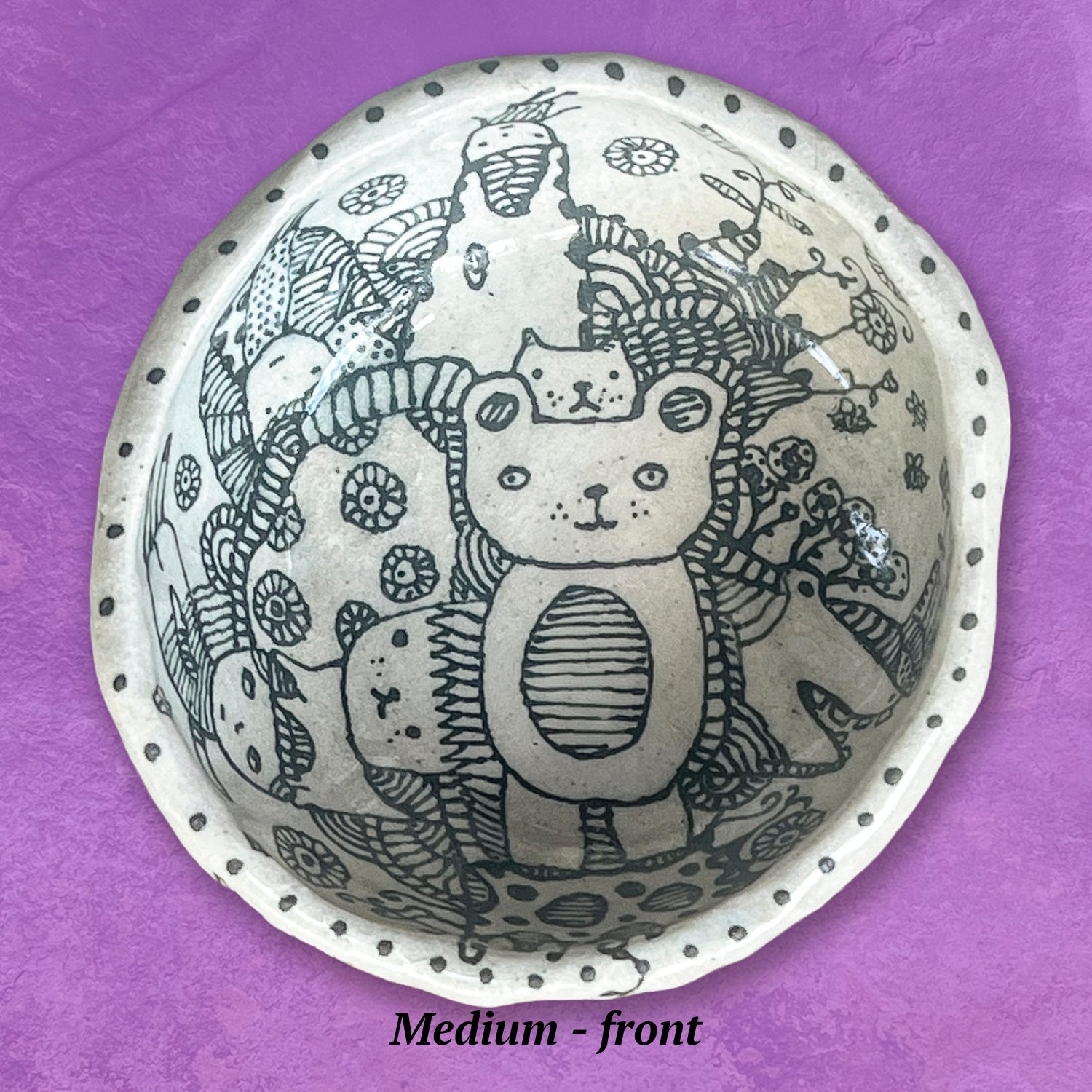 Decorative bowl with animal illustrations in black and white.
