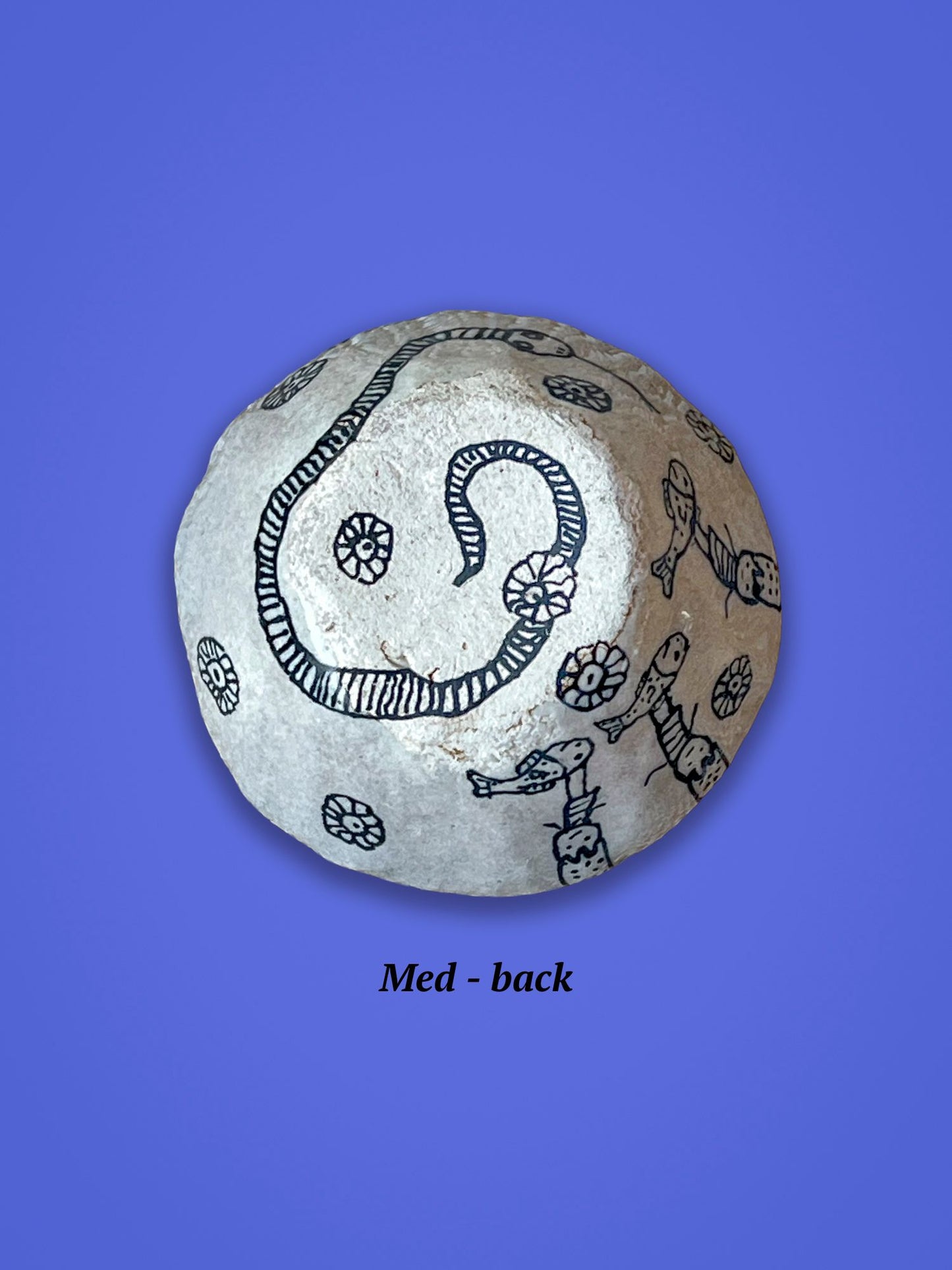 The back side of the previous piece shows black designs of flowers and a serpentine shape.