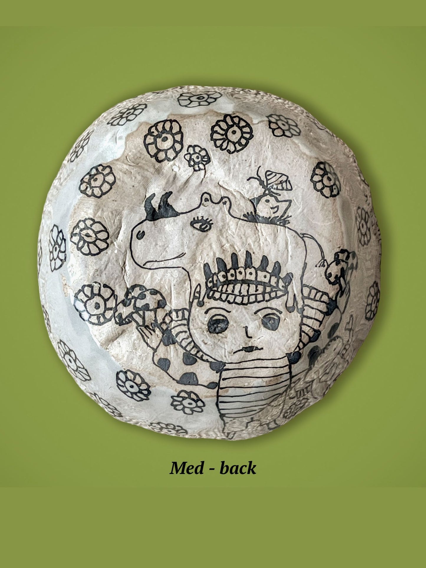 The backside of the previous bowl has  black line art with the shape of a rhino and small figure surrounded by flowers.