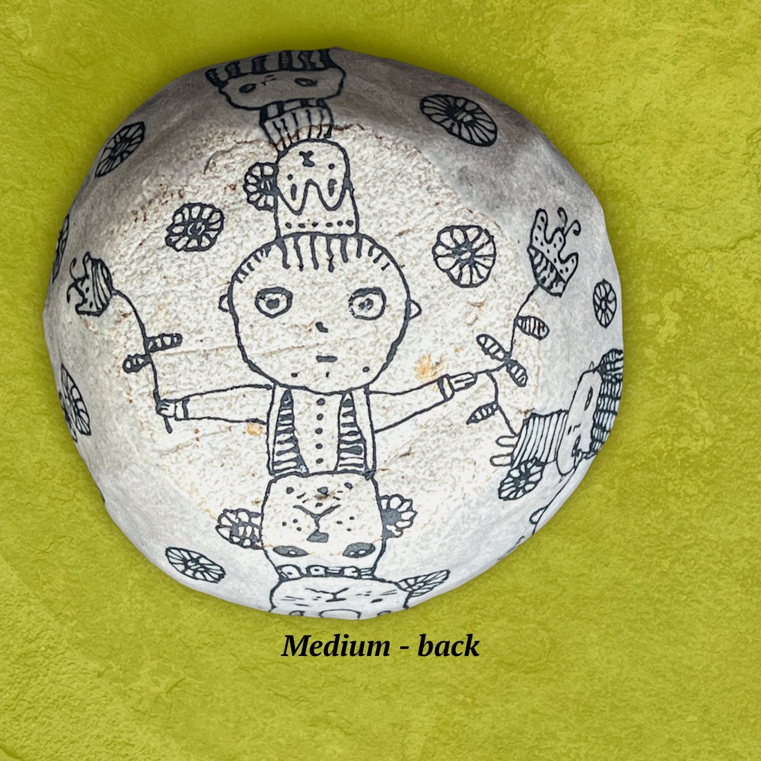 Decorative bowl underside with black line art shows a whimsical boy holding flowers.