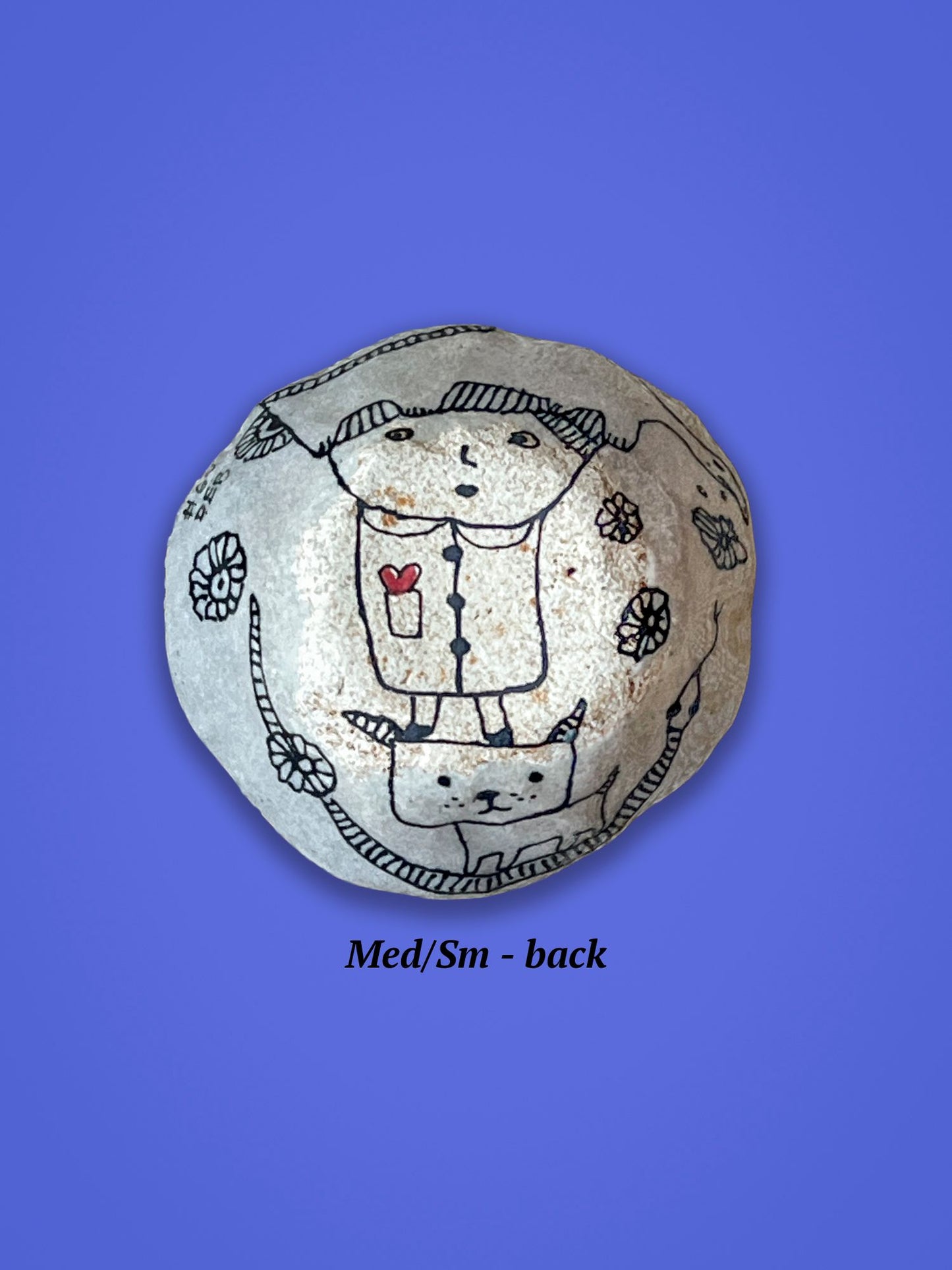 This is the backside of the previous bowl. It has a small figure standing on a dog. The figure has a small red heart in its pocket.