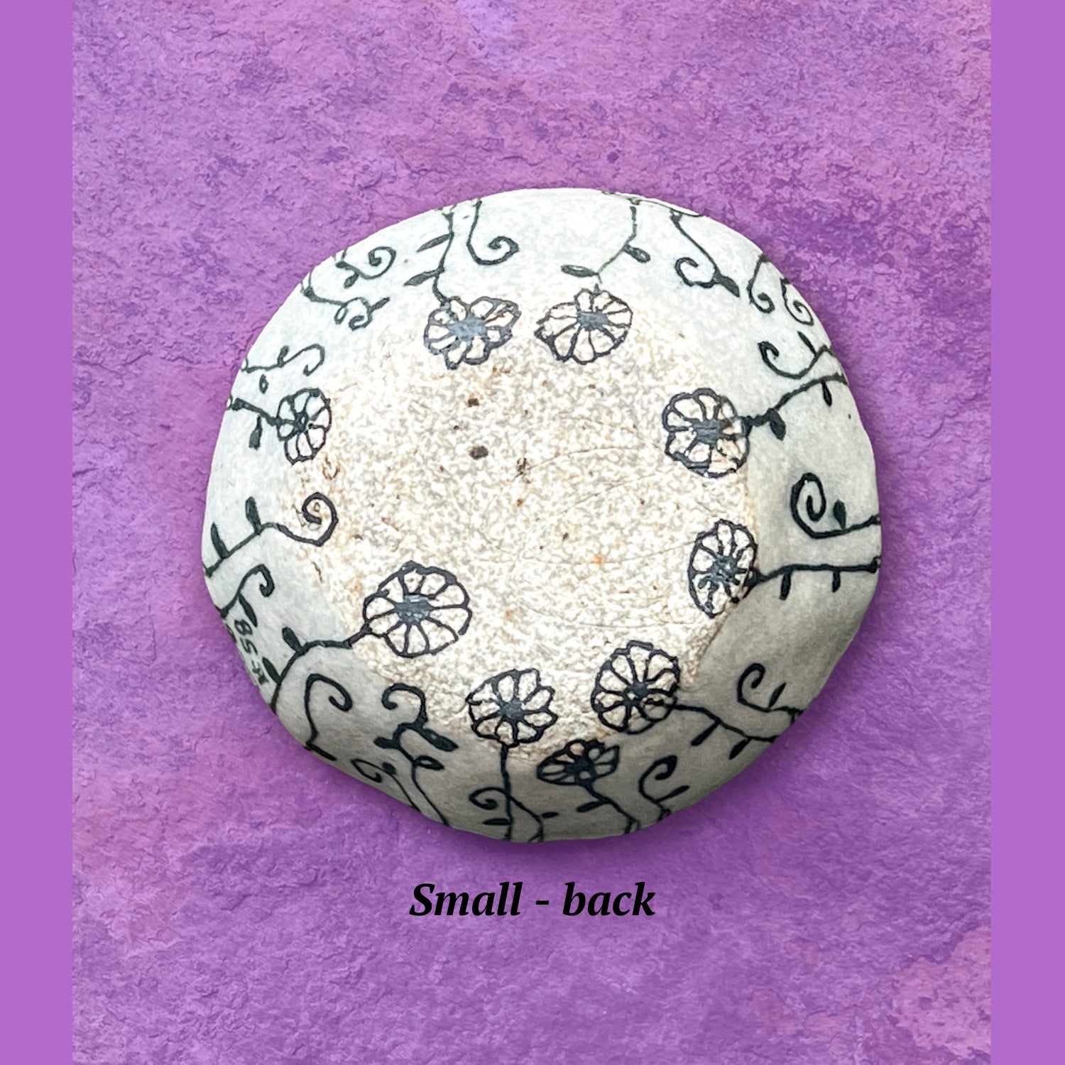 This image shows the backside of a bowl with flower designs. The finish is matte, not glossy like the front.