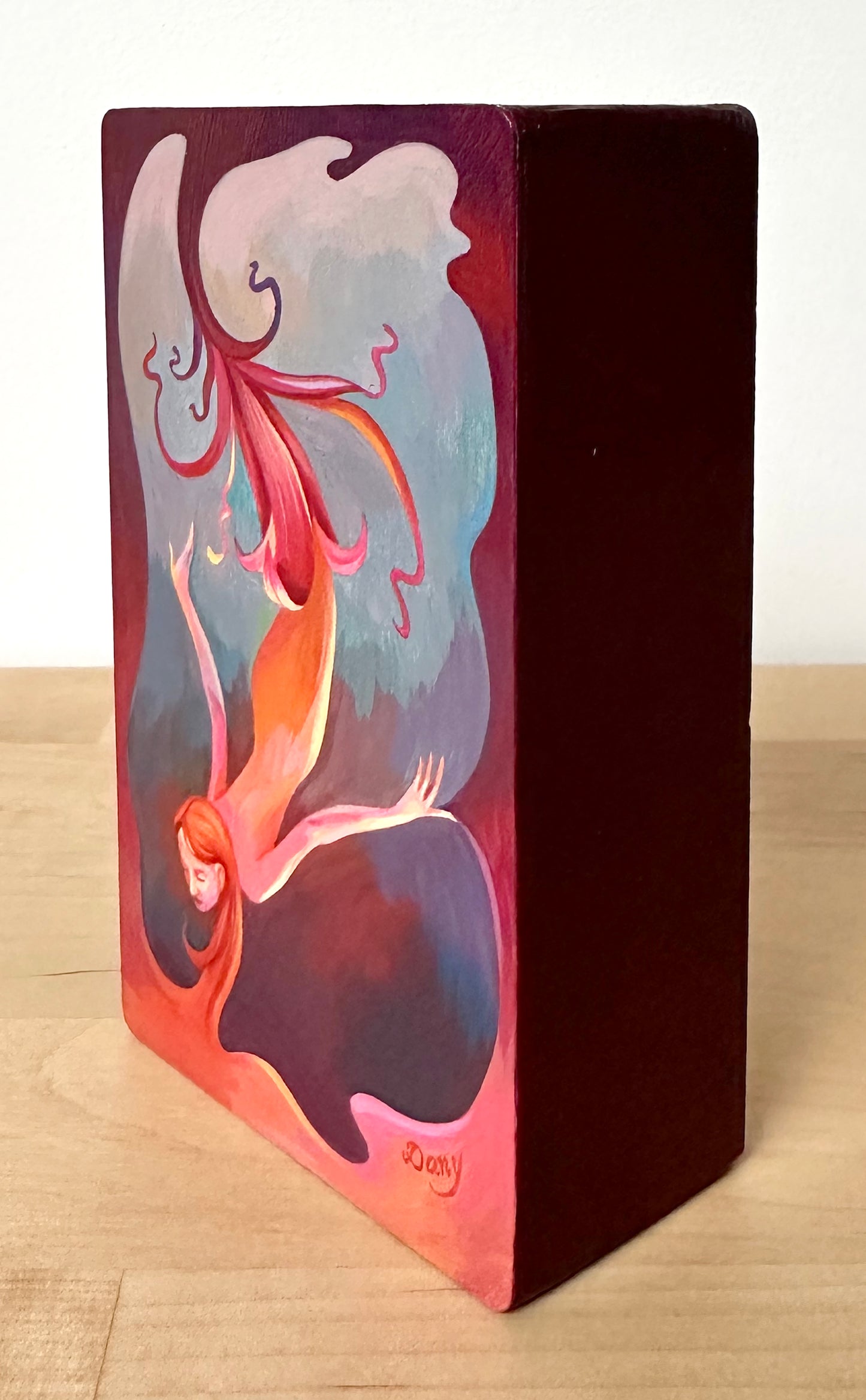 This side image shows that the painting's sides have been painted in a dark red and varnished.