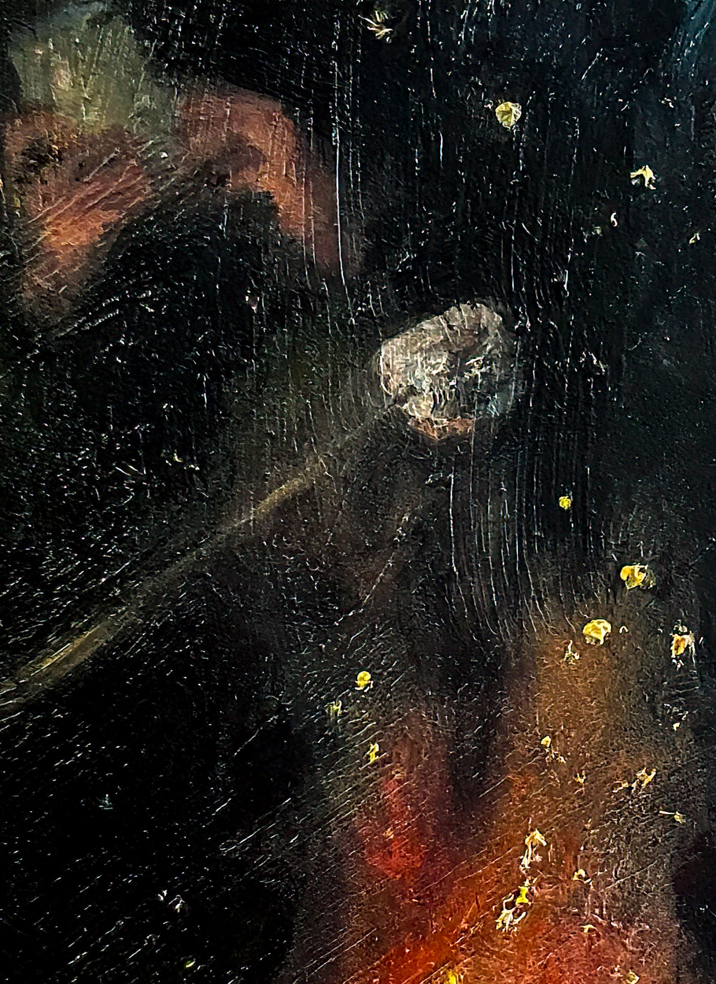 This image shows a close up look at the marshmallow roasting as embers of the fire fly up to the sky.