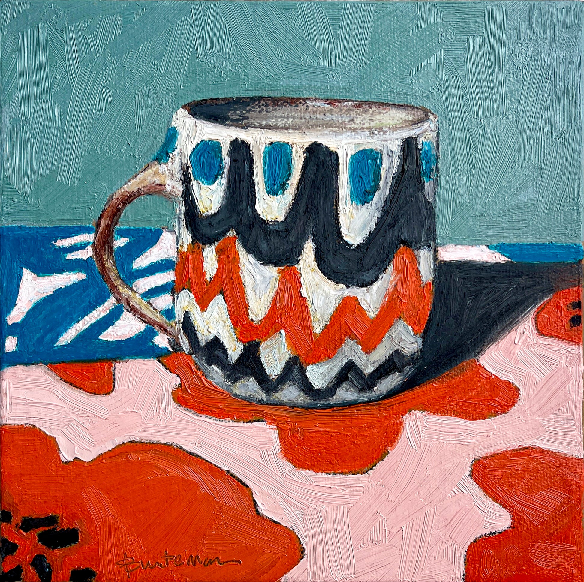 This mug of retro design has a color palette of teal, black, red and white. It coordinates with the table top it sits upon and a teal background wall. The design is scalloped rows of color.