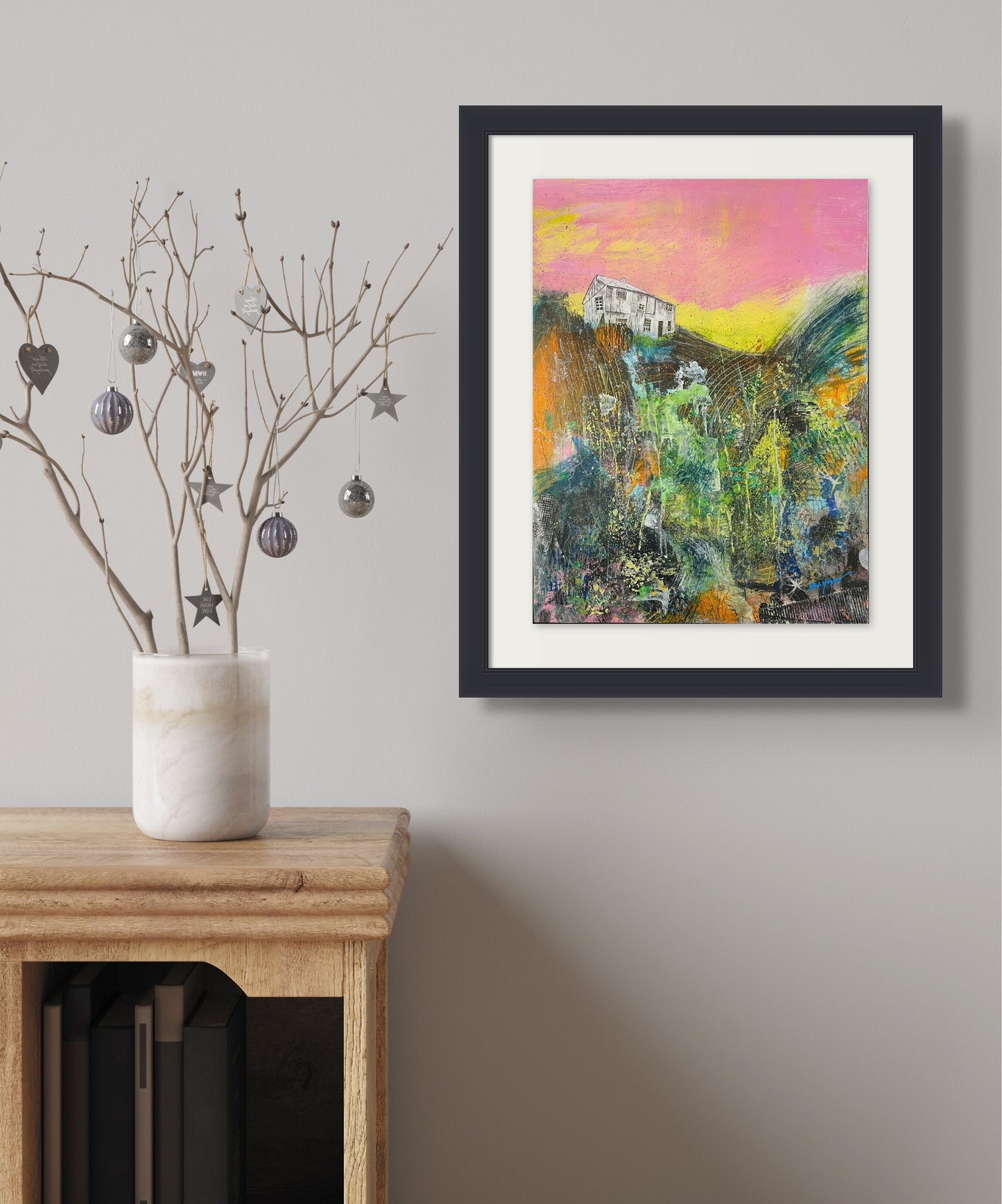 Abstract acrylic work shows a white house on the edge of a cliff at sunrise. Colors of brown, green, grey and white create an image of the side of the cliff, shown in situ; artist Bob Hogue; 18"Wx24"H
