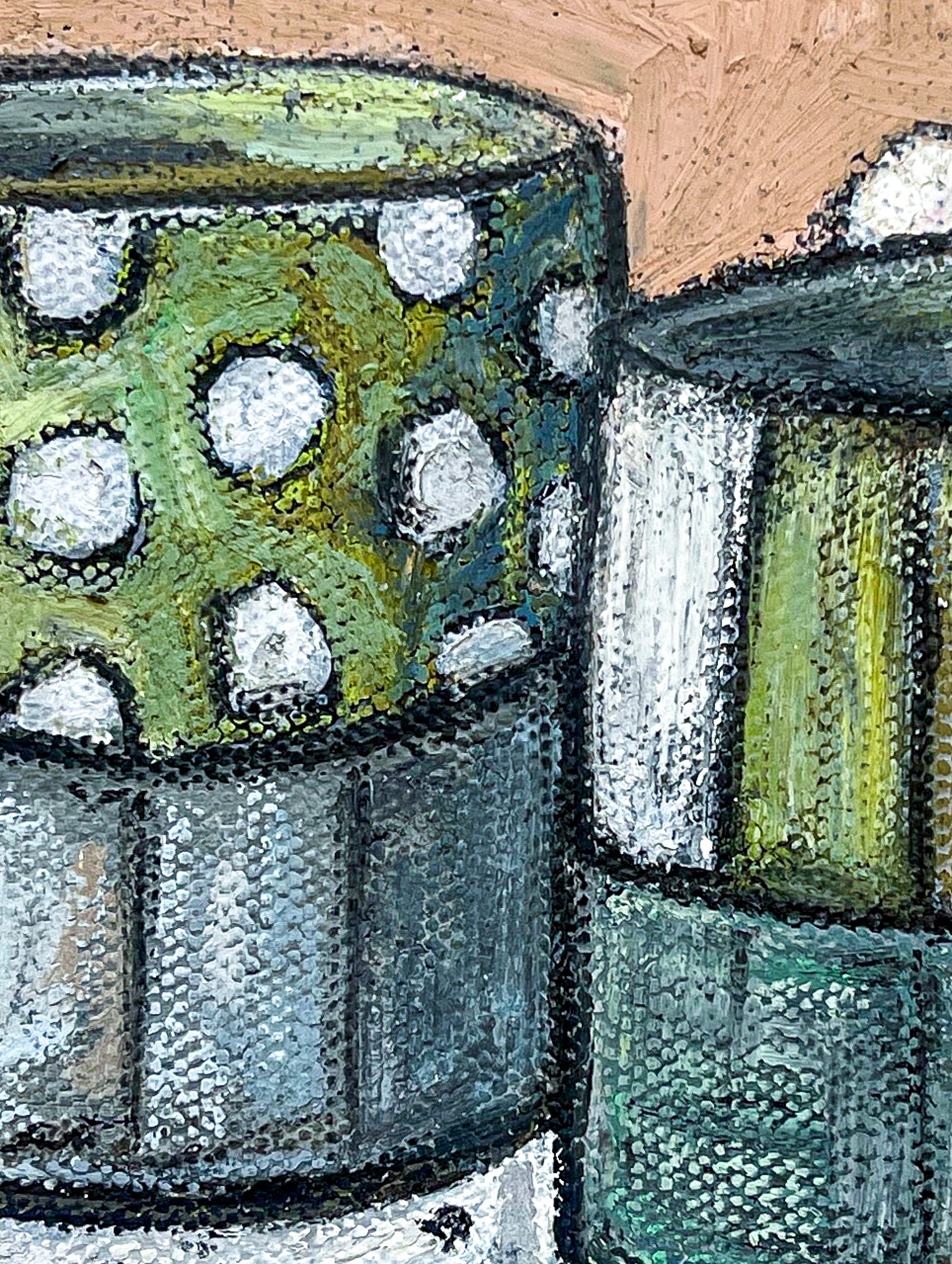 This close up image shows the design of the two mugs. Each has stripes of white, gray and green and the one of the left has a panel of white polka dots on a green background.