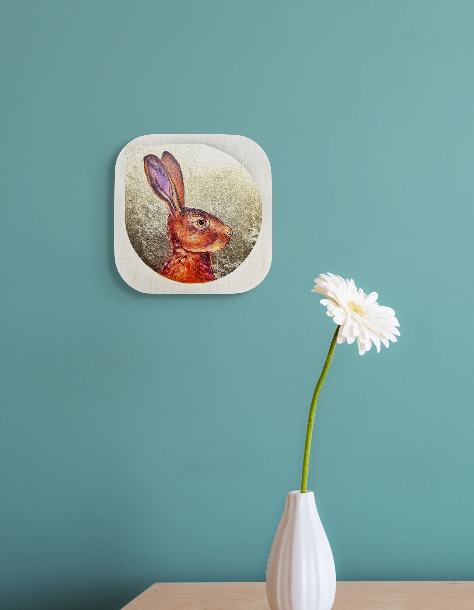 In situ image of Antennas Up! on aqua wall over a vase with a single white flower; artist Marie Lavallee