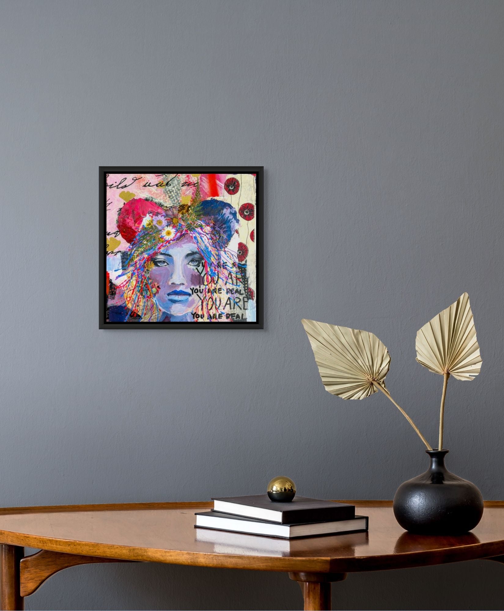 Framed image of Bears Repeating on a gray wall above a wooden table with decorative items.