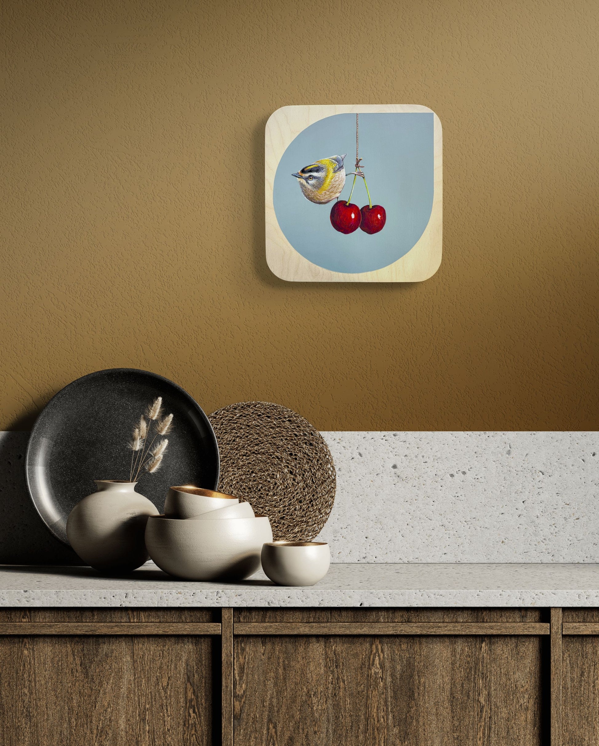 In situ image of Cherry Picker on  light brown wall over shelf of ceramic bowls, vase, and plate