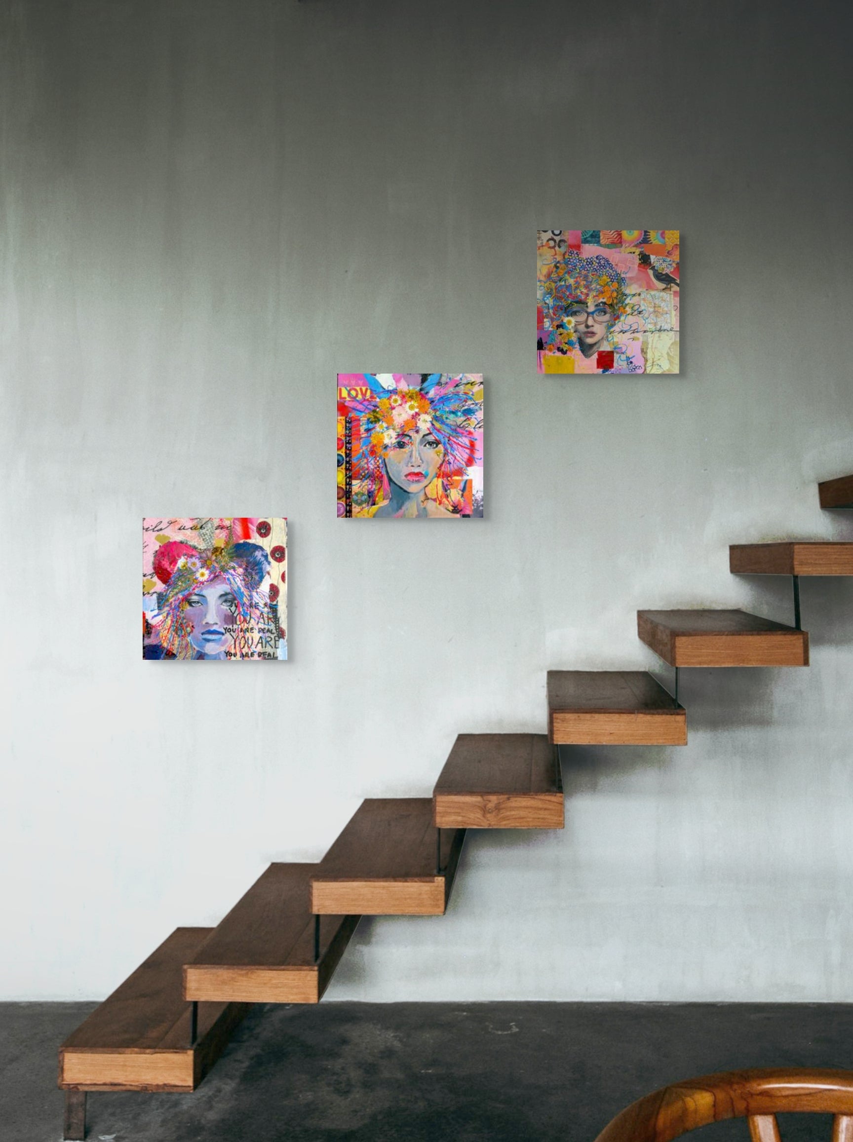 Gina Barnes' three mixed media collages hang together on a wall above wooden stairs