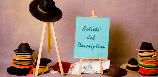Image of many hats and sign saying 'artists' job description'