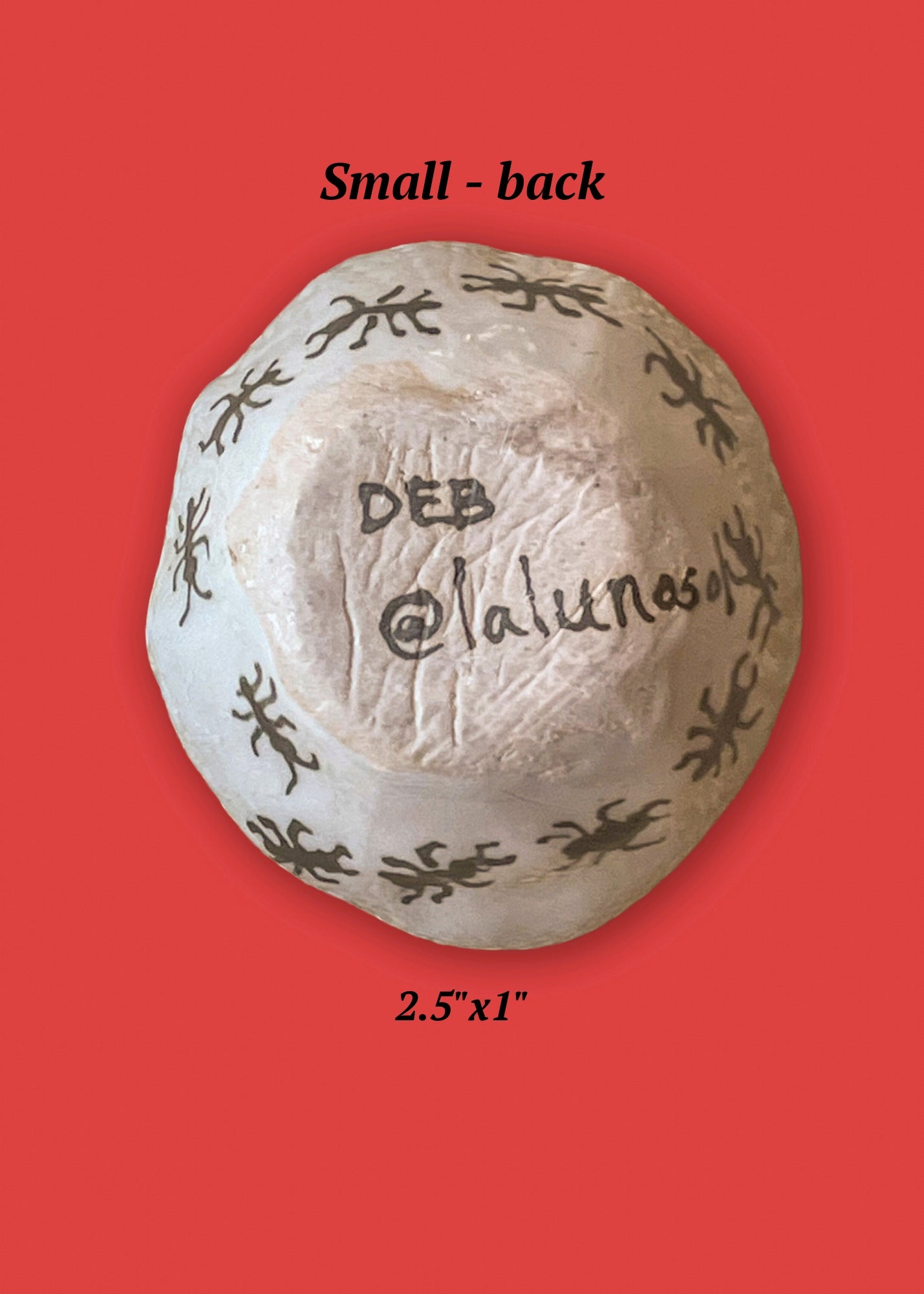 The back side of the smallest bowl in the set has the artist's signature and the sides of the bowl is covered in an army of ants.