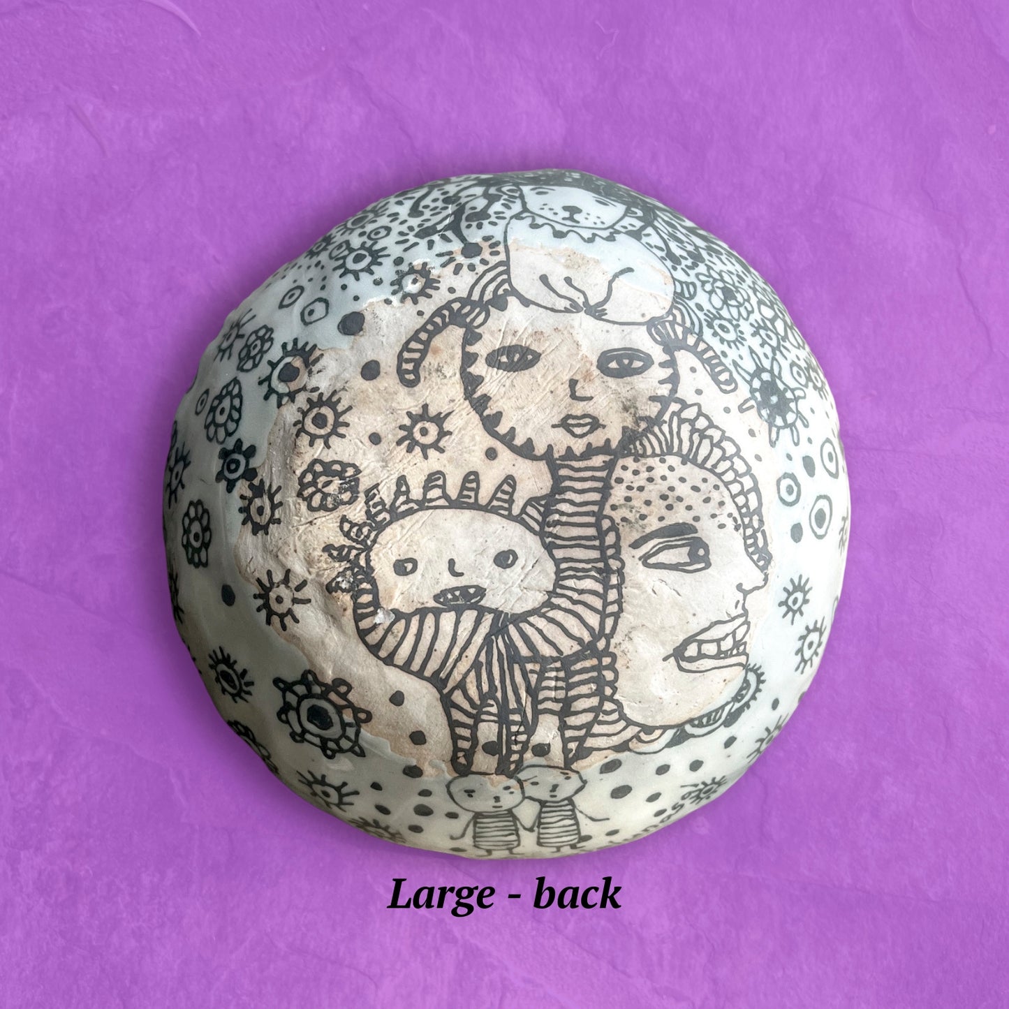 This image shows the backside with artistic designs. The finish is matte, not glossy like the front. 