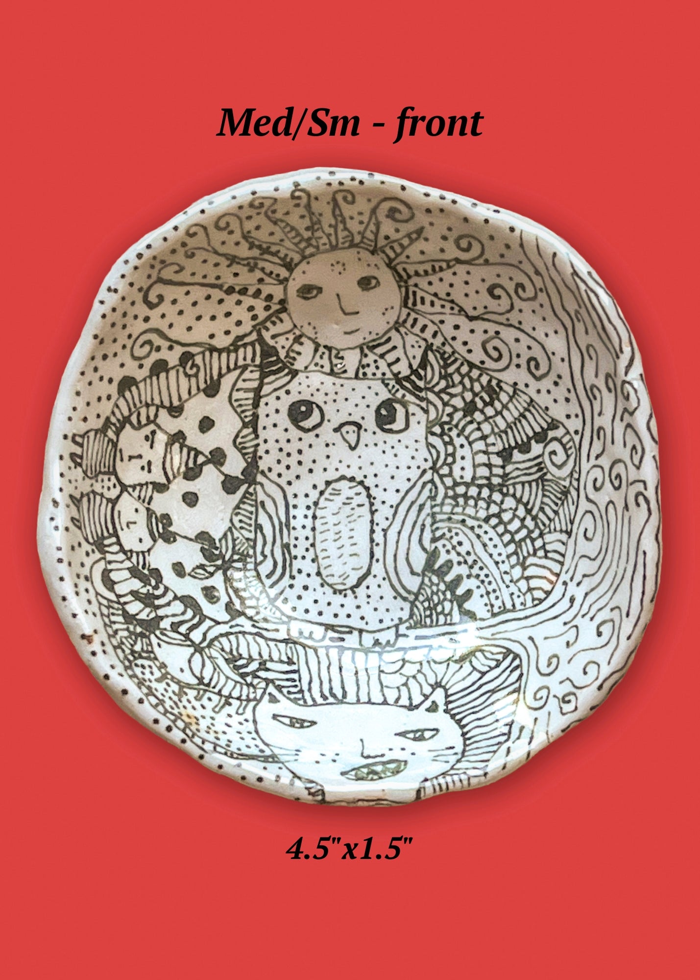 Decorative ceramic bowl with artistic design on a red background. The design is all in black drawing an owl with a sun atop its head is in the center of the bowl.