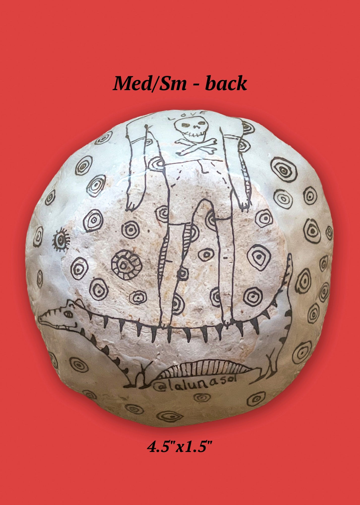 This is the back view of the small/medium bowl and features a figure with a pirate skull on its shirt standing on a tiger or long cat. 