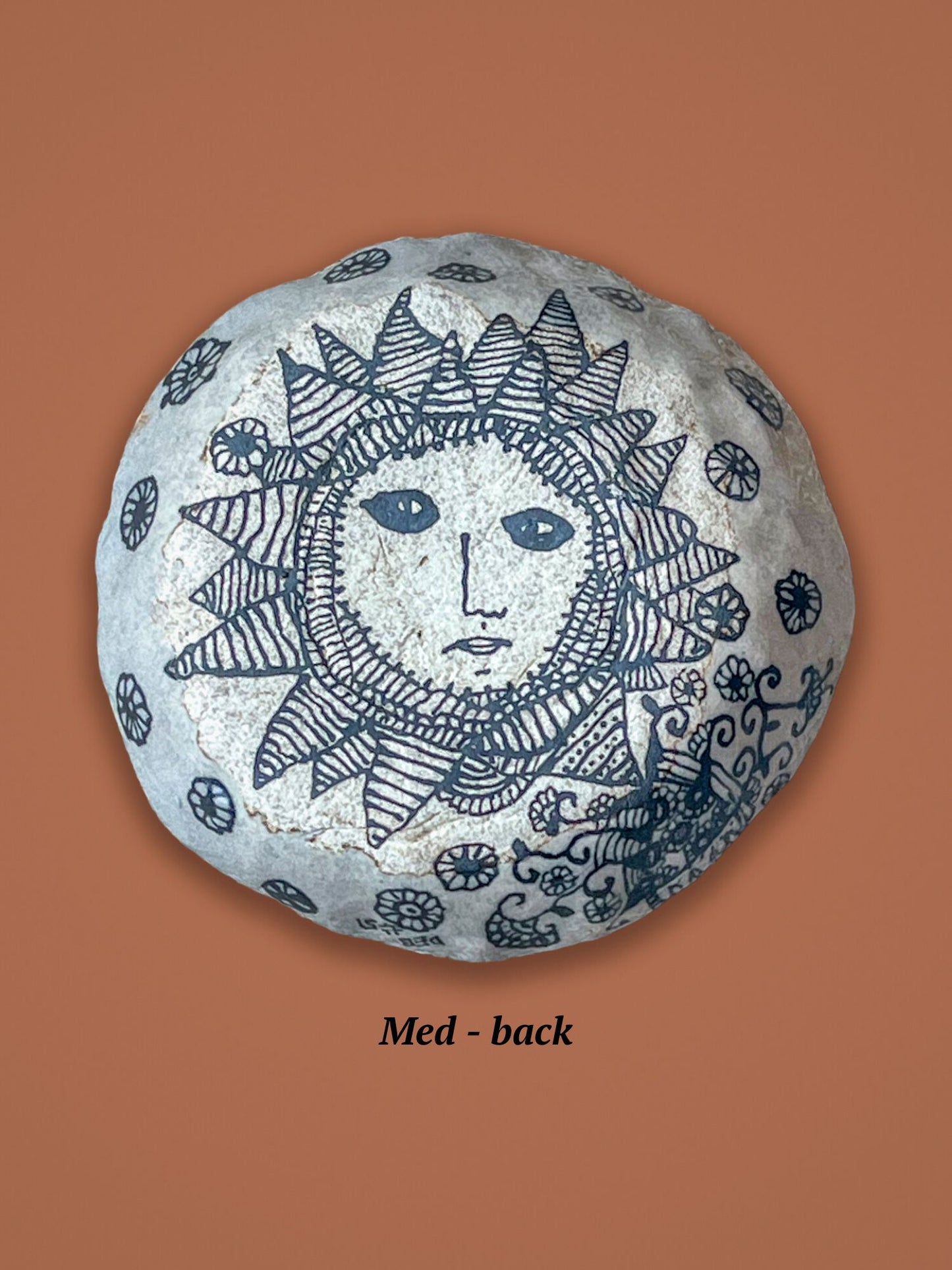 Backside of the previous bowl with sun face design. This image is of the backside of a small bowl. The top side has a glossy finish, this side doesn't.