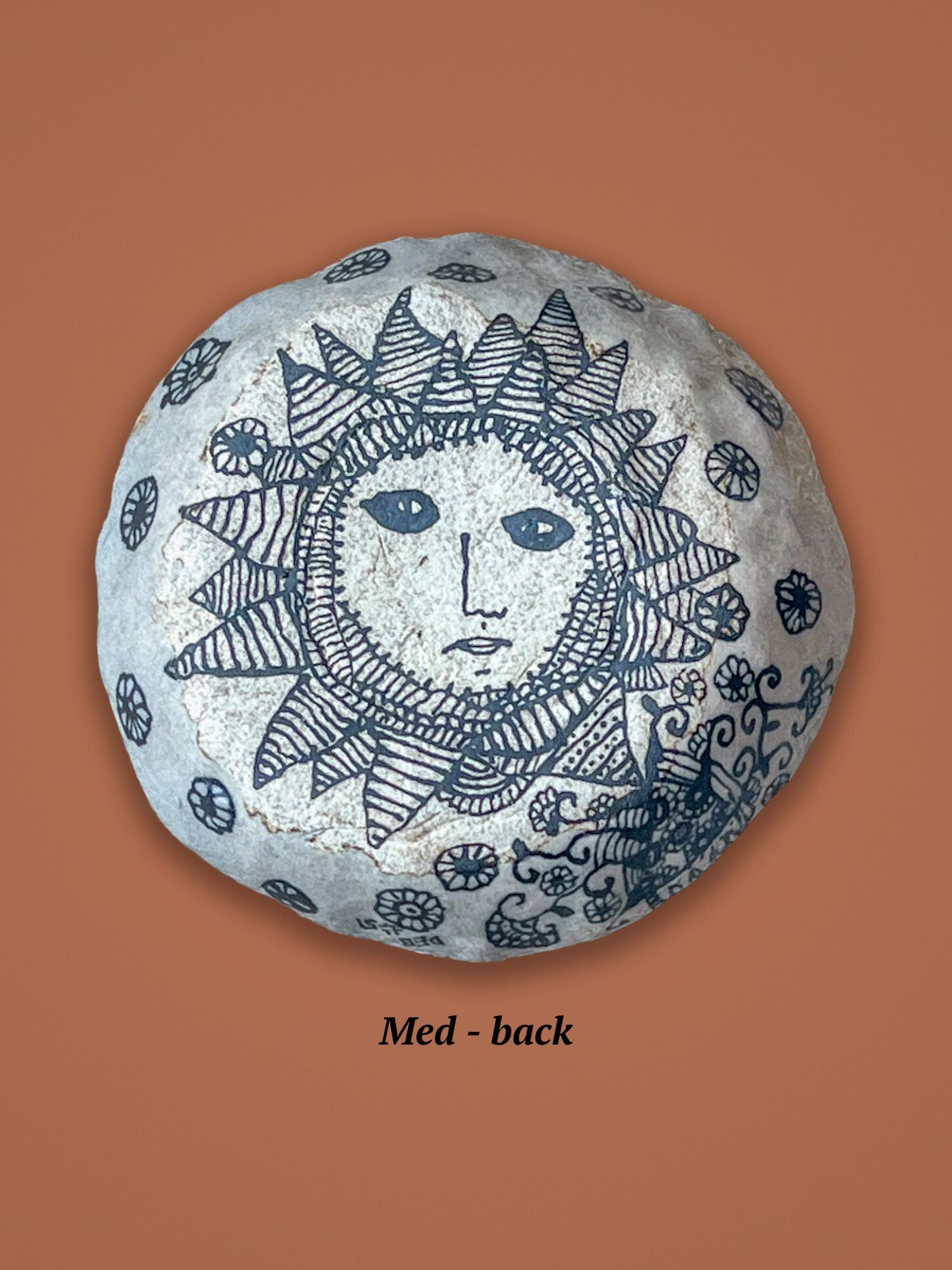 Backside of the previous bowl with sun face design. This image is of the backside of a small bowl. The top side has a glossy finish, this side doesn't.