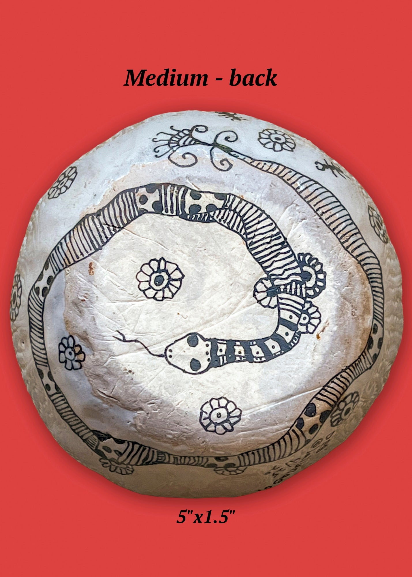 This is the back view of the medium ceramic bowl in this set. It features a striped snake surrounded by flowers.