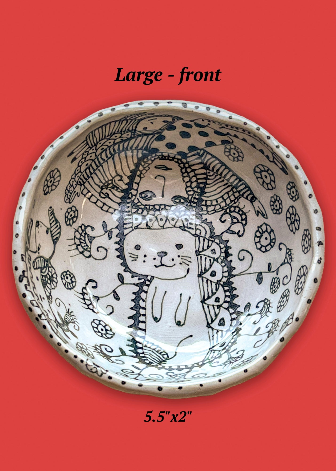 Ceramic bowl with animal designs on a red background. A cat is featured in the center of the bowl.