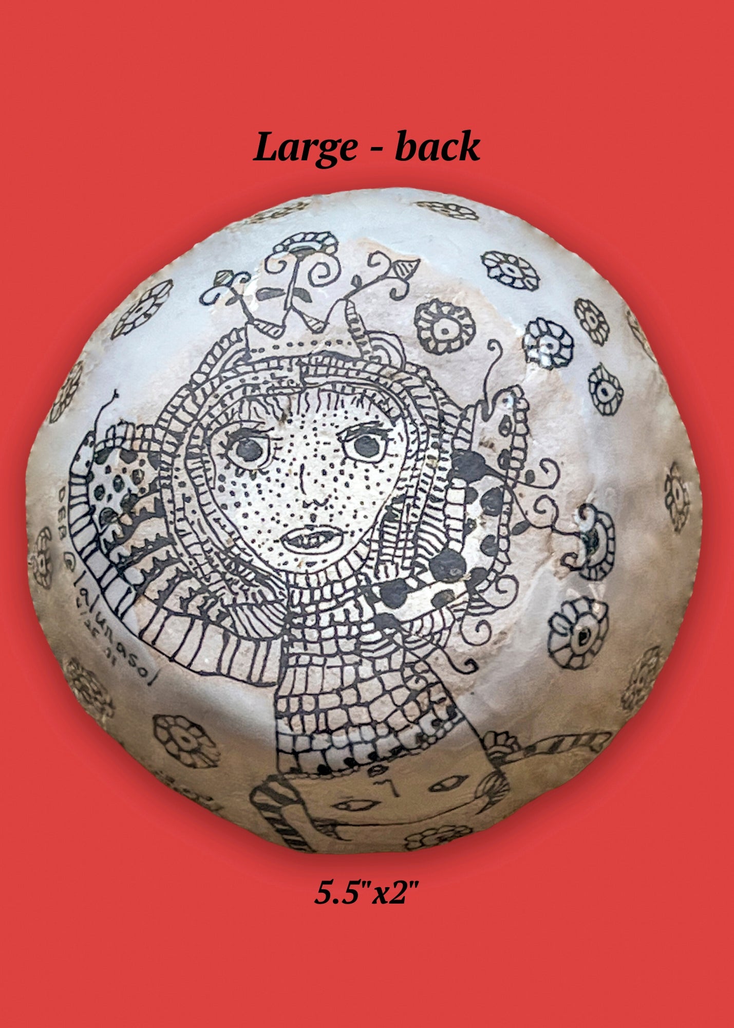 This shows the backside of the large bowl. It features a figure with a two heads and arms like snakes.