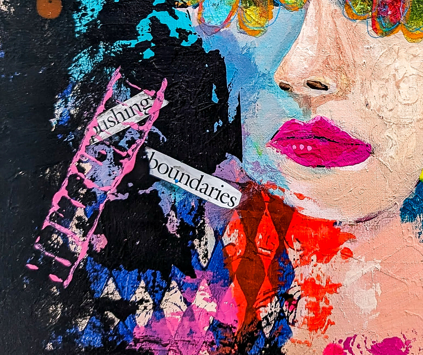 Close up view of Rebel's face and the mixed media elements of the painting which include the cut out words "pushing" and "boundries"