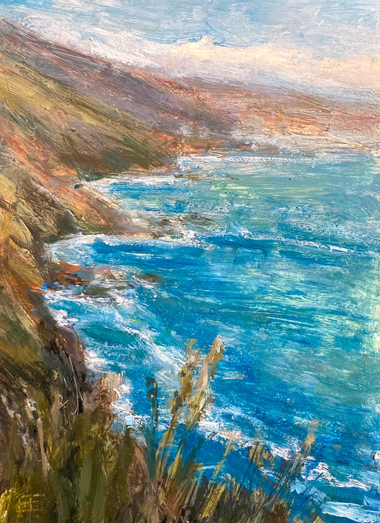 The coastline of Big Sur is a beautiful sight in this small landscape by E.E. Jacks. The blue of the water, accents by white caps crashes agains the cliff's of the coast. A small group of reeds and flowers is in the foreground