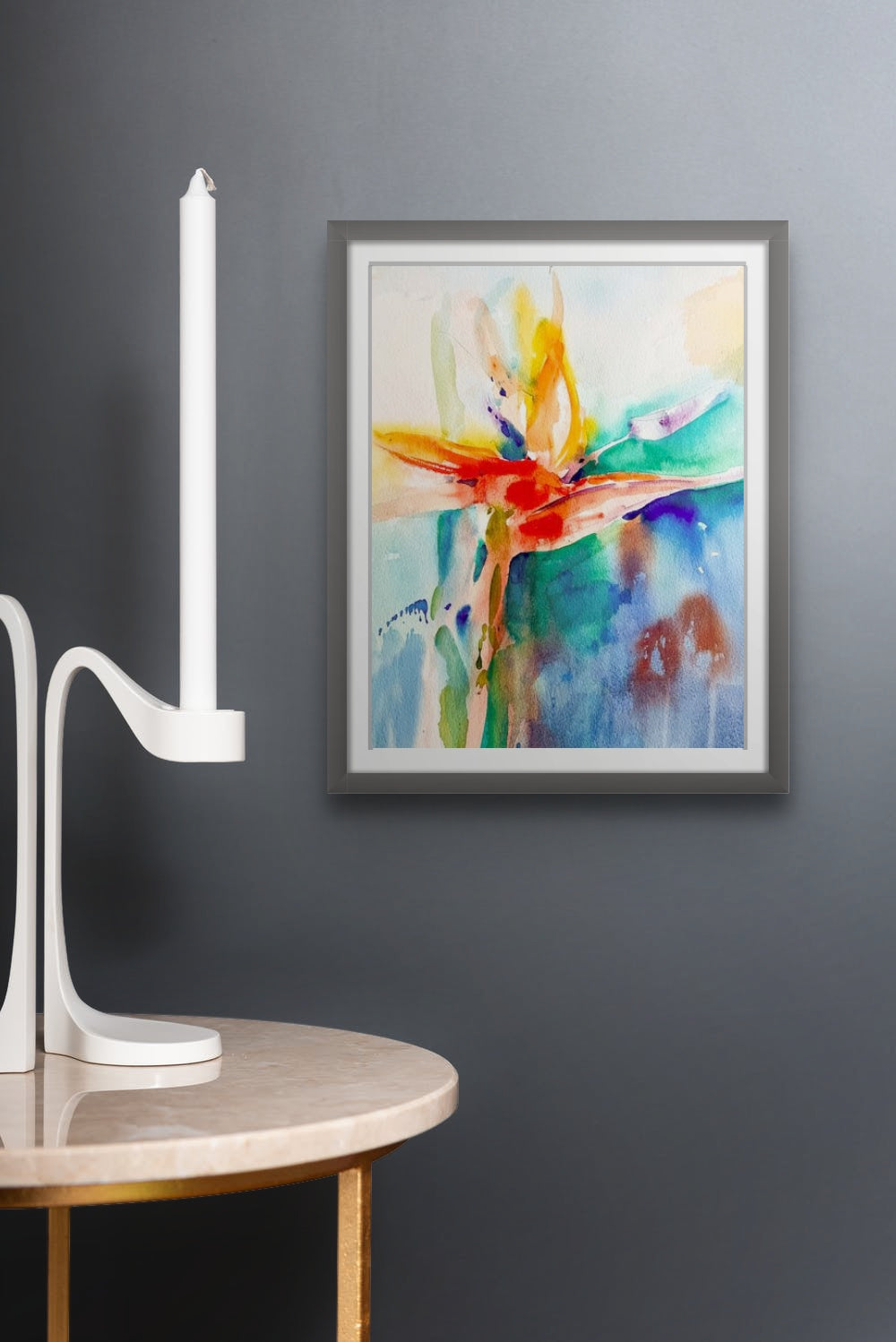 Colorful watercolor painting of Bird of Paradise, using red, yellow for flower, green, blue for background; artist Teri Gammalo; shown on wall in situ