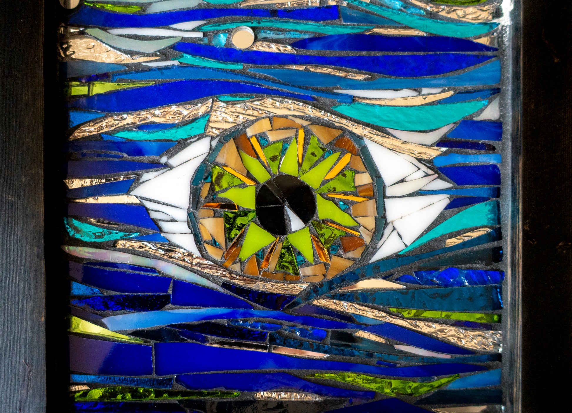 Closeup of glass  mosaic  green eye; artist Denise Marshall