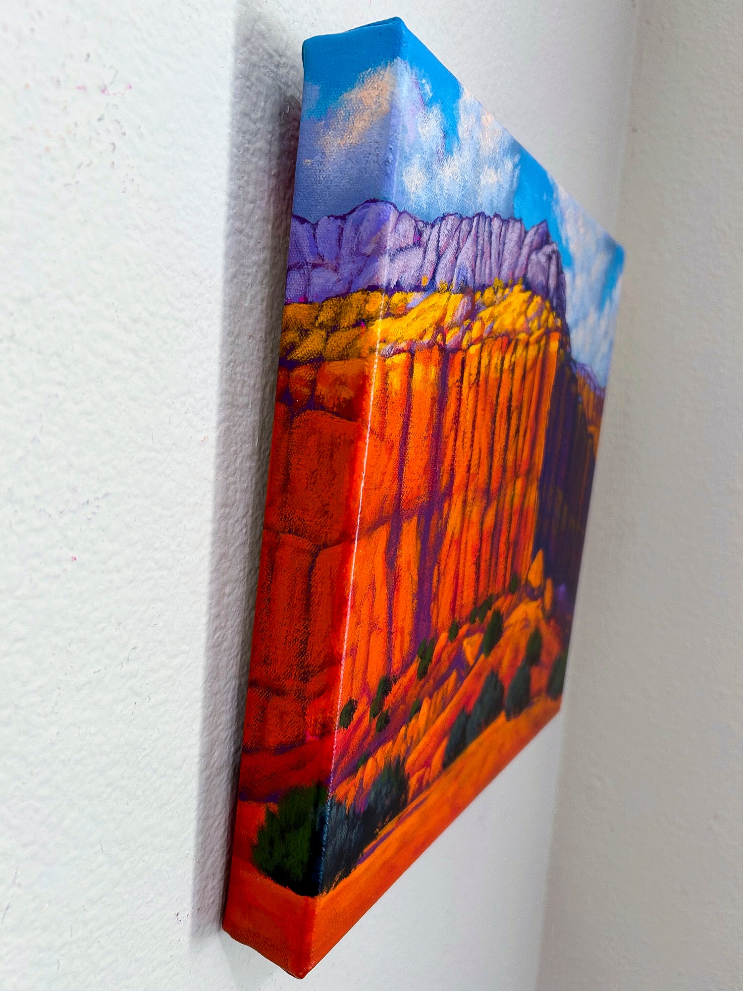 This side view shows the depth of the canvas painting as it hangs on the wall.  The painting on canvas continues as it wraps around the edges.