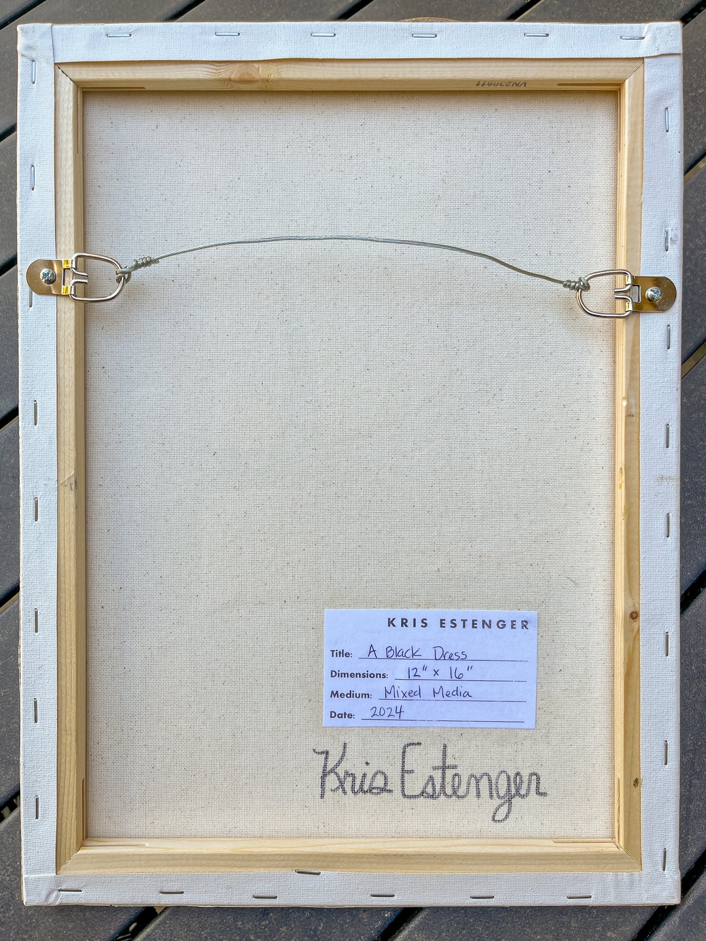 The back view shows the wire hanger and artist's signature. 