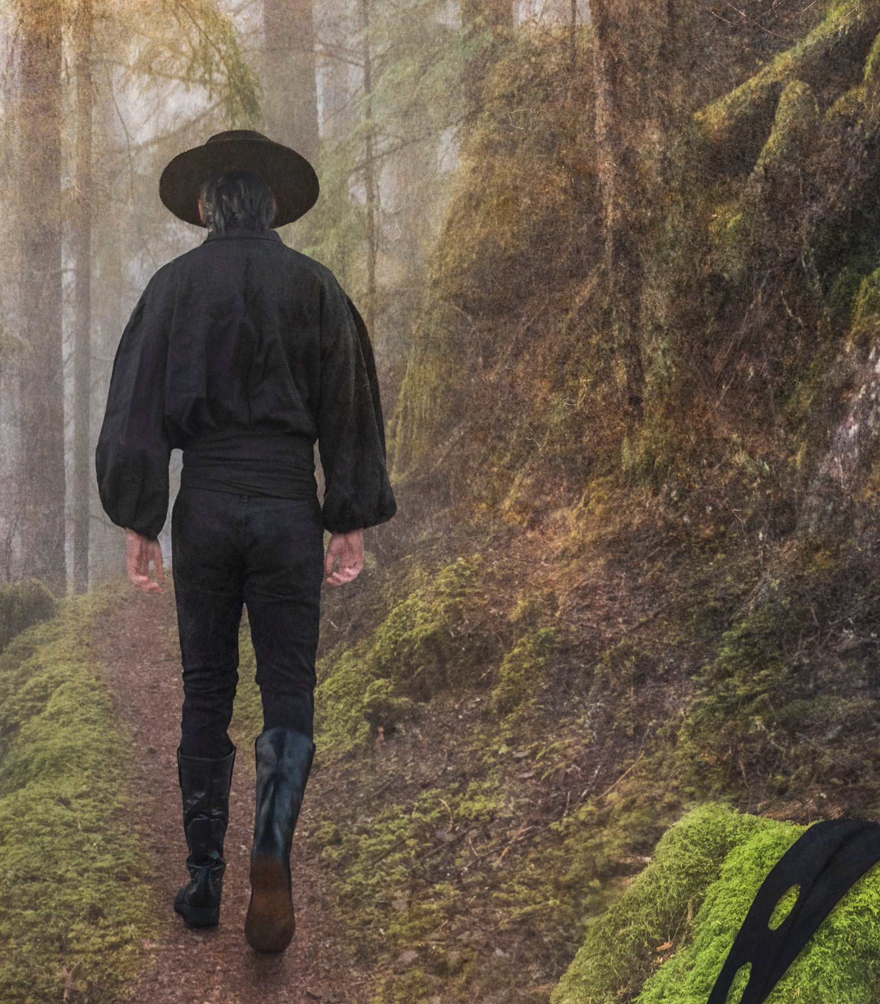 Close up of "Zorro" - his mask lays on a rock in the forefront of the image as he walks away. 