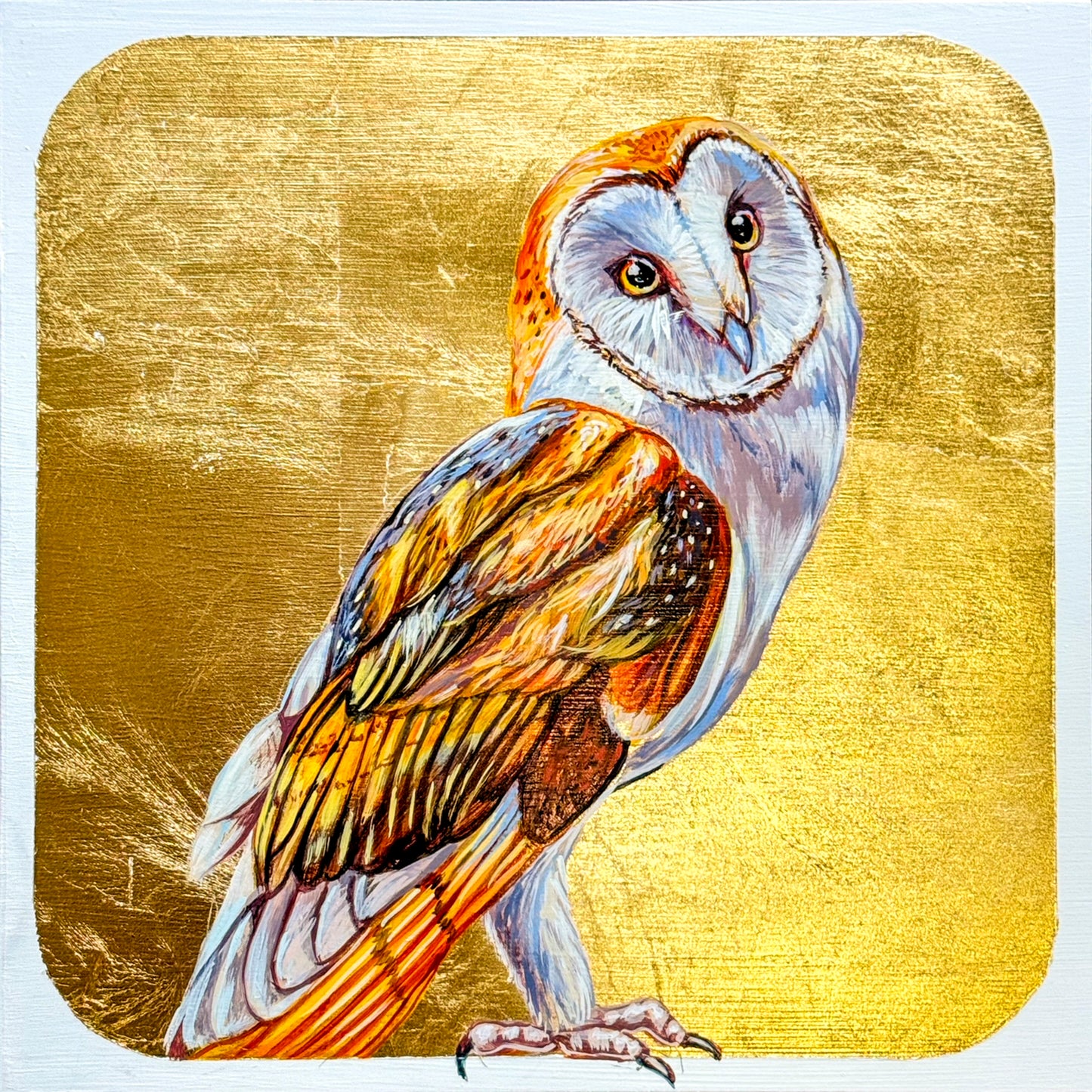 A stunning background of gold leaf highlights the beautiful feathering of Marie's owl whose head is titled in curiosity. The image includes the full head and body of this beautiful bird. 