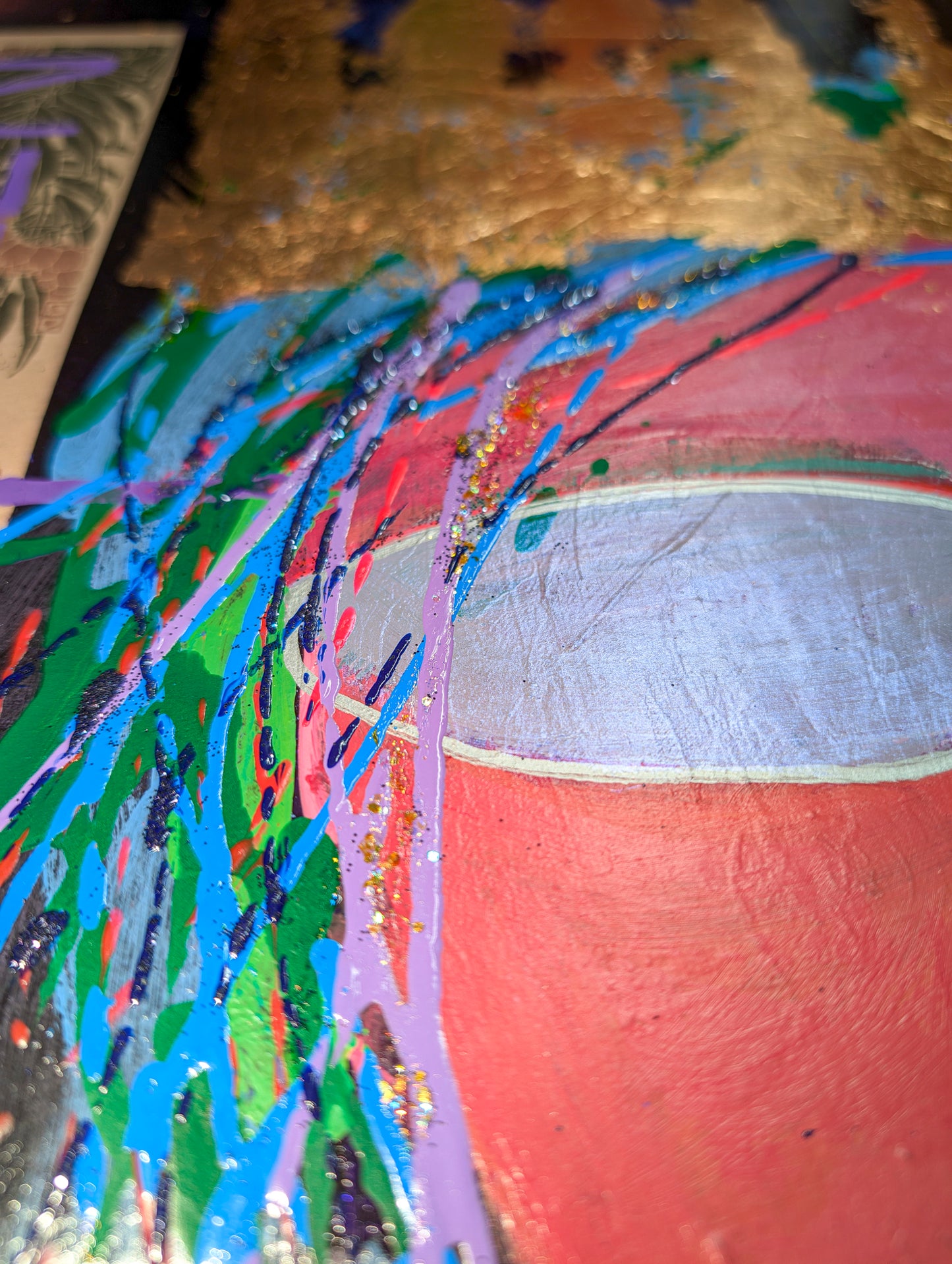 This close up image shows the variety of colors of blues, greens and yellows in the woman's hair and a close up of the sunglasses.