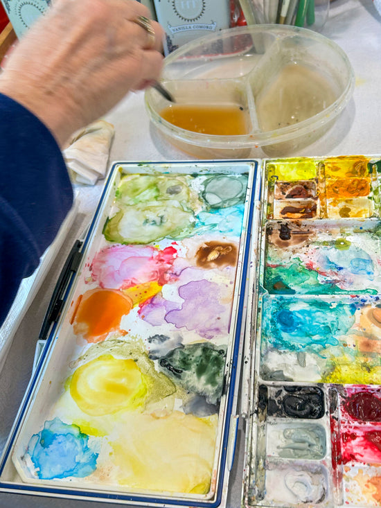 Artist with brush, water and paint palette