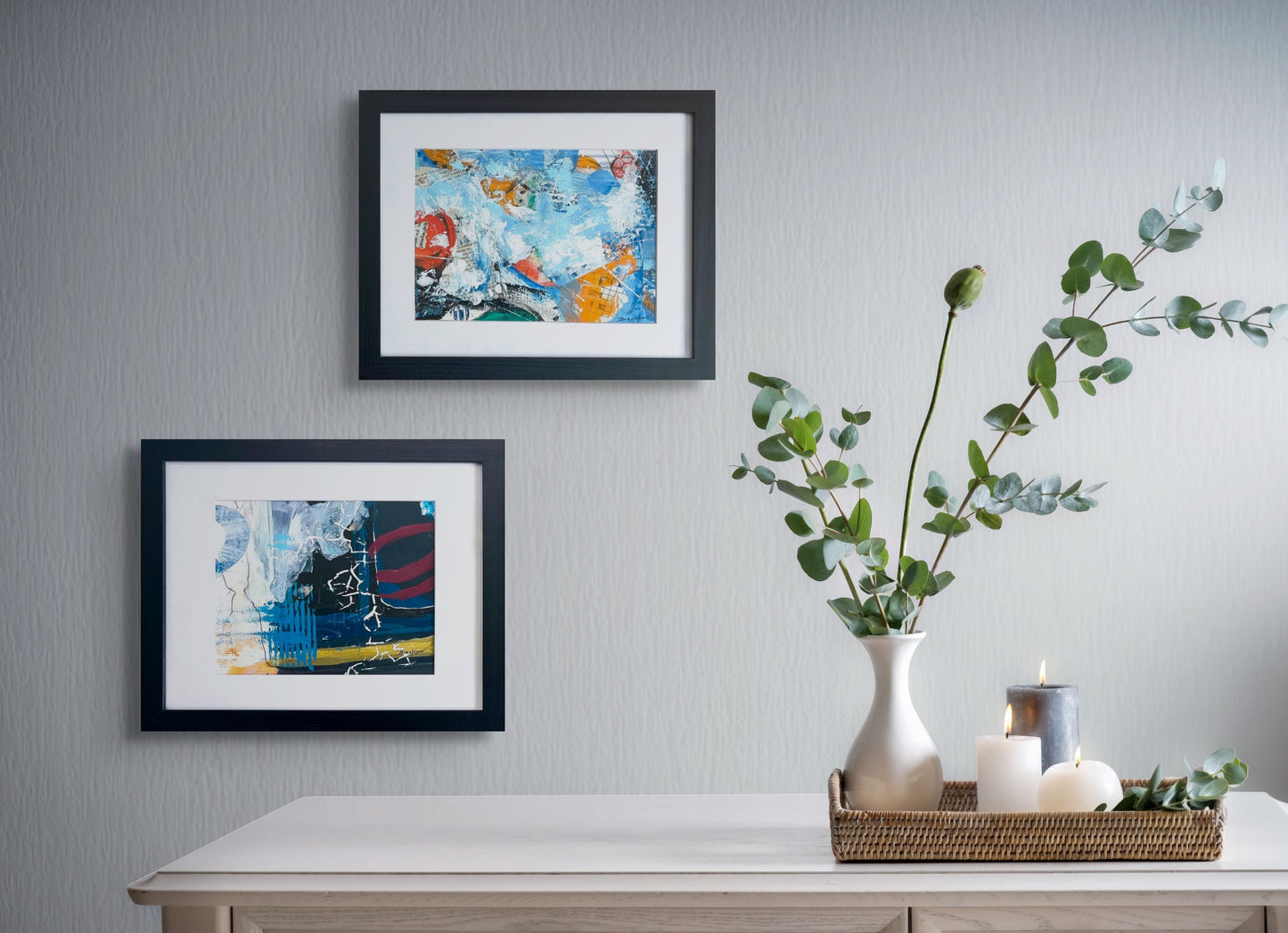 Colorful abstract painting using acrylic; predominant blue and white, with touch of red and yellow; artist Bob Hogue; 8"x10" and w/black wood frame and white mat 11"x 14"; shown in situ on wall paired with a second abstract painting by the artist