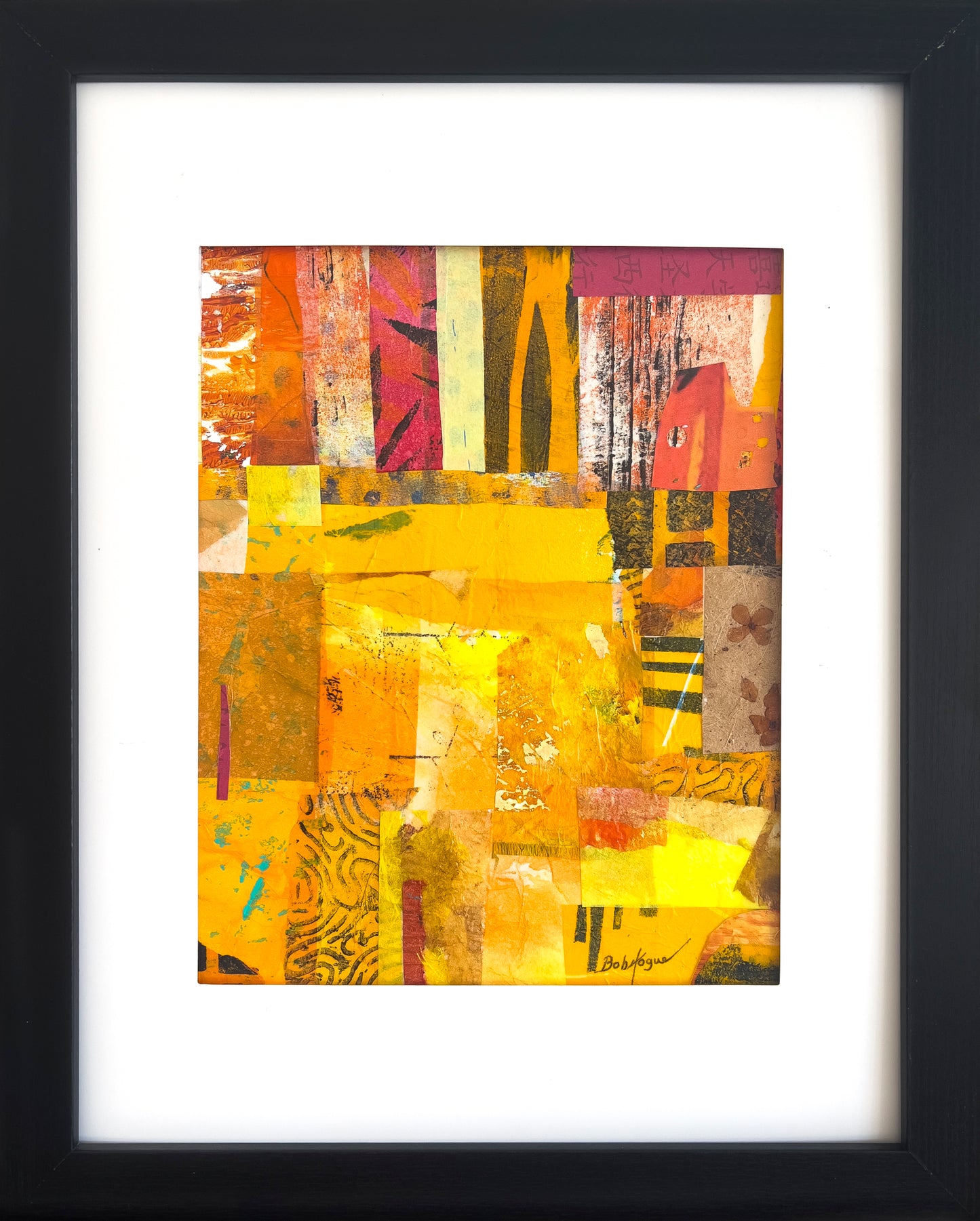 Colorful collage in strong yellows and reds  using  Bob Hogue's painted pieces titled "Safari" in a black wood frame with a white mat.