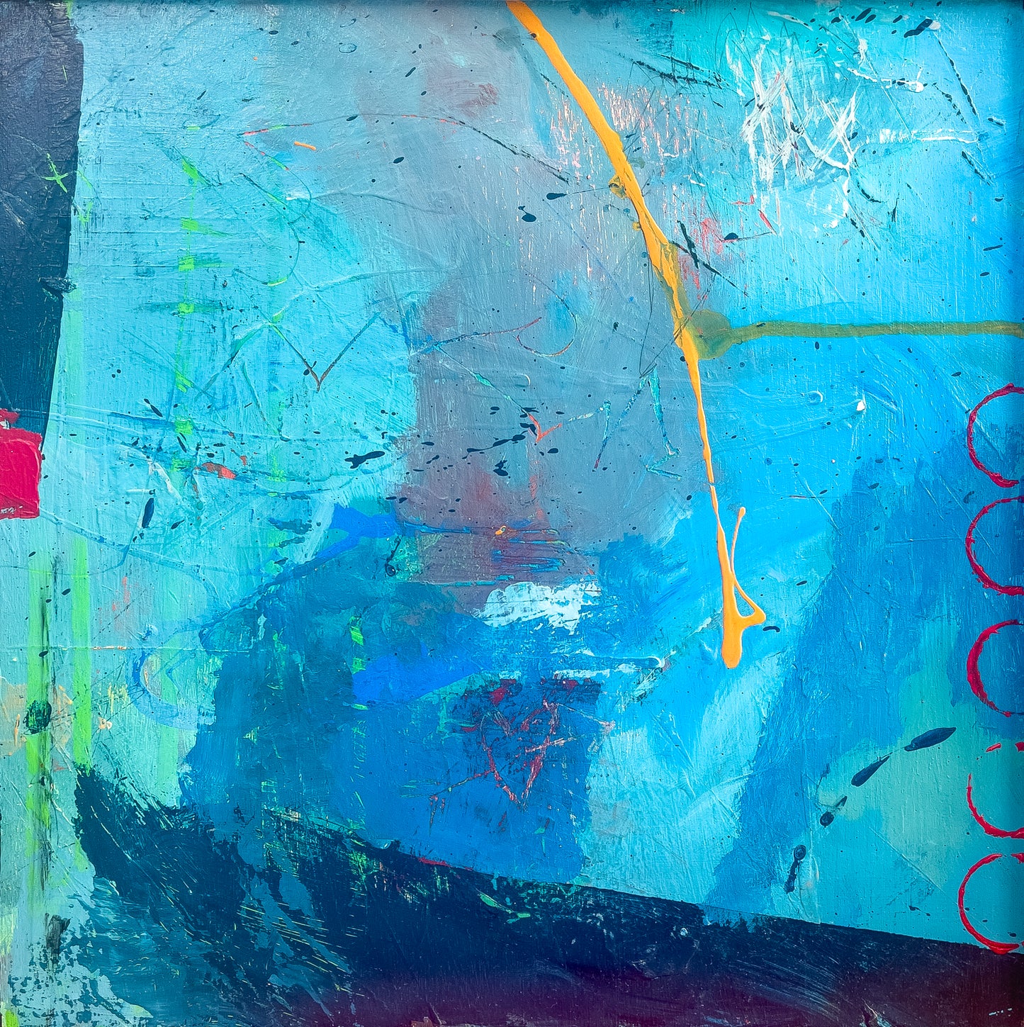 This is one of a set of three blue abstract paintings. It is mixed media with pieces of paper, hues of blue, a splash of red and a yellow streak which pops out of the background.