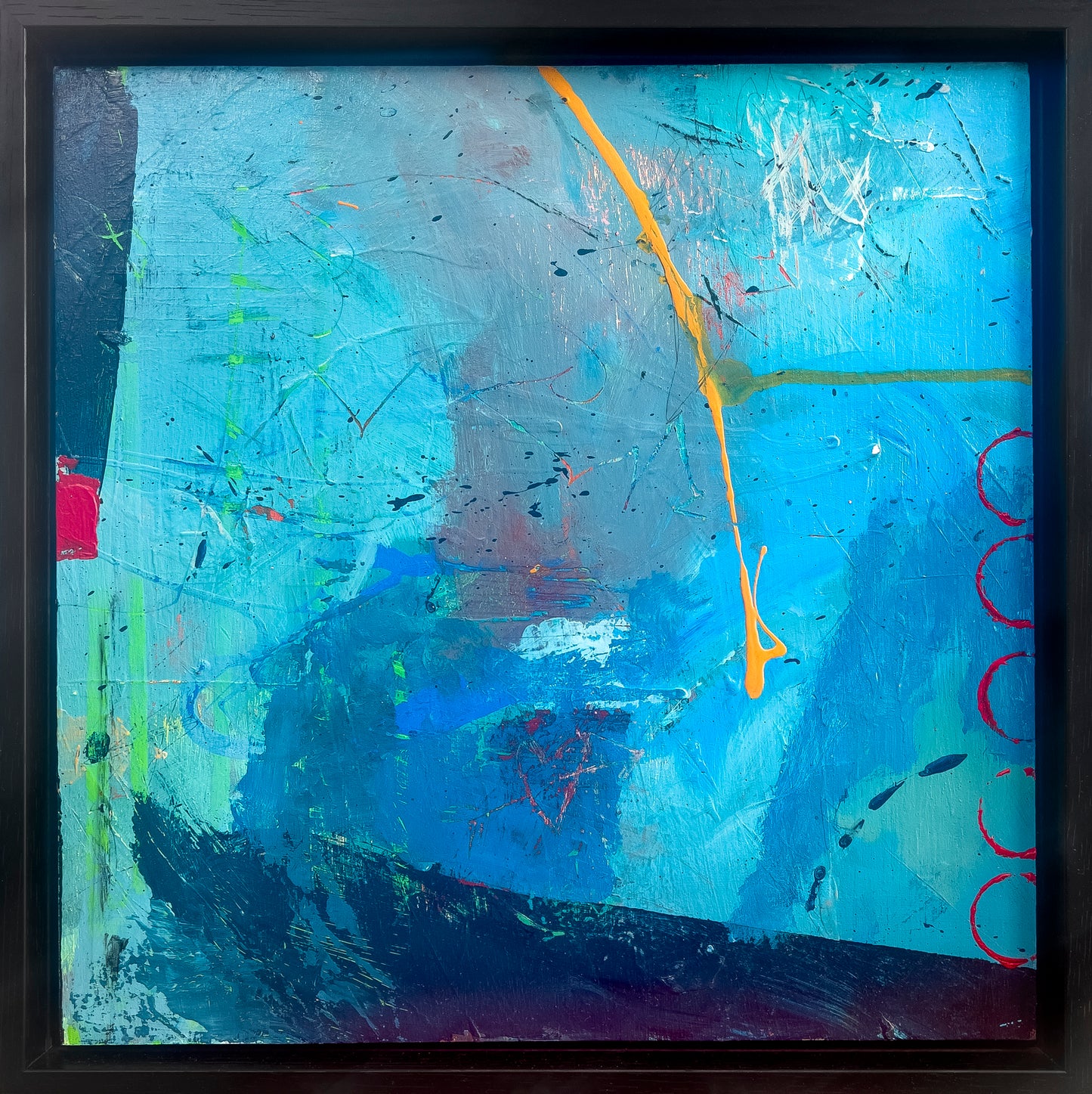 Blue Series #3 shown in its black wooden floater frame. Colors are hues of blue, splashes of red and a streak of yellow which goes down the center of the painting.