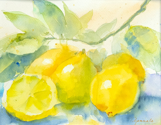 Five lemons rest on a gray blue surface some still clinging to the branch. The green of the leaves is accented with yellow and blue and the lemons, through varied in their shades of yellow show fresh and inviting fruit. 