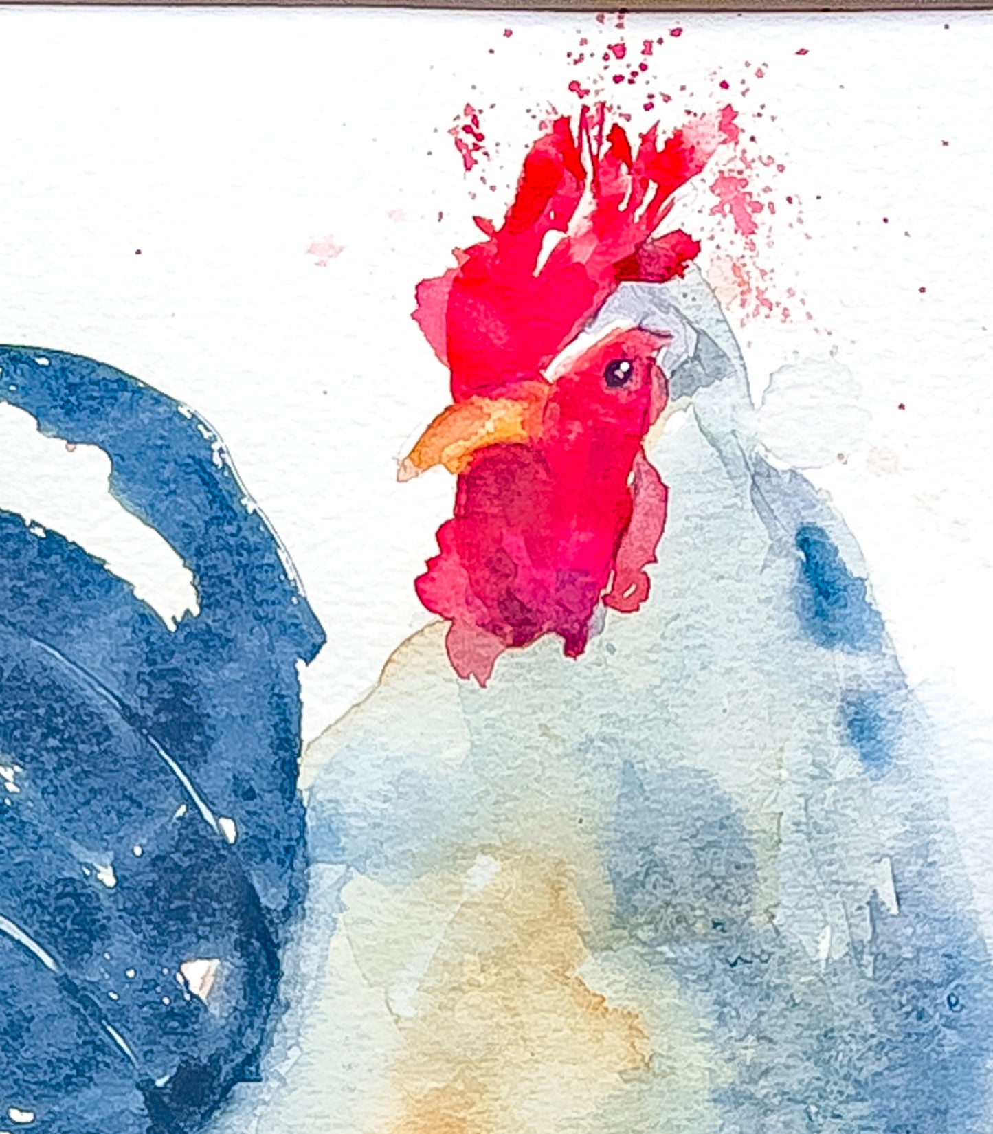 This image shows the rooster's head close up demonstrating the blending of the water colors. 