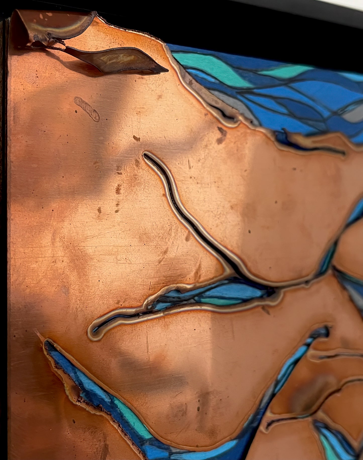 This close up of the copper cuts show the dimension of the metal and the acrylic blues that shine through. 