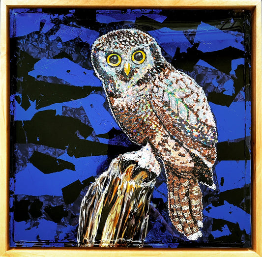 Colorful acrylic painting of owl on blue background; owl is comprised of various colored sequins; resin coating on top; artist Marie Lavallee