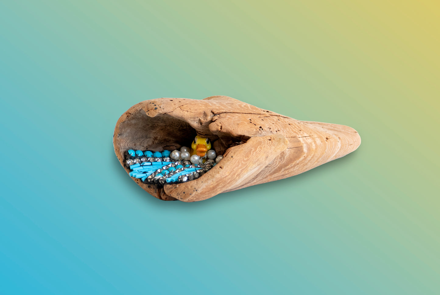 Natural driftwood sculpture decorated with beads, stones, and small toy duck by Denise Marshall title 'Duck at Sea''; 4"Wx2"H