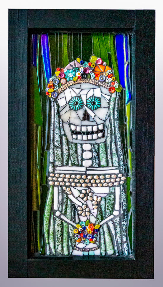 Colorful glass mosaic image of Catrina holding flowers with floral headers; artist Denise Marshall; framed