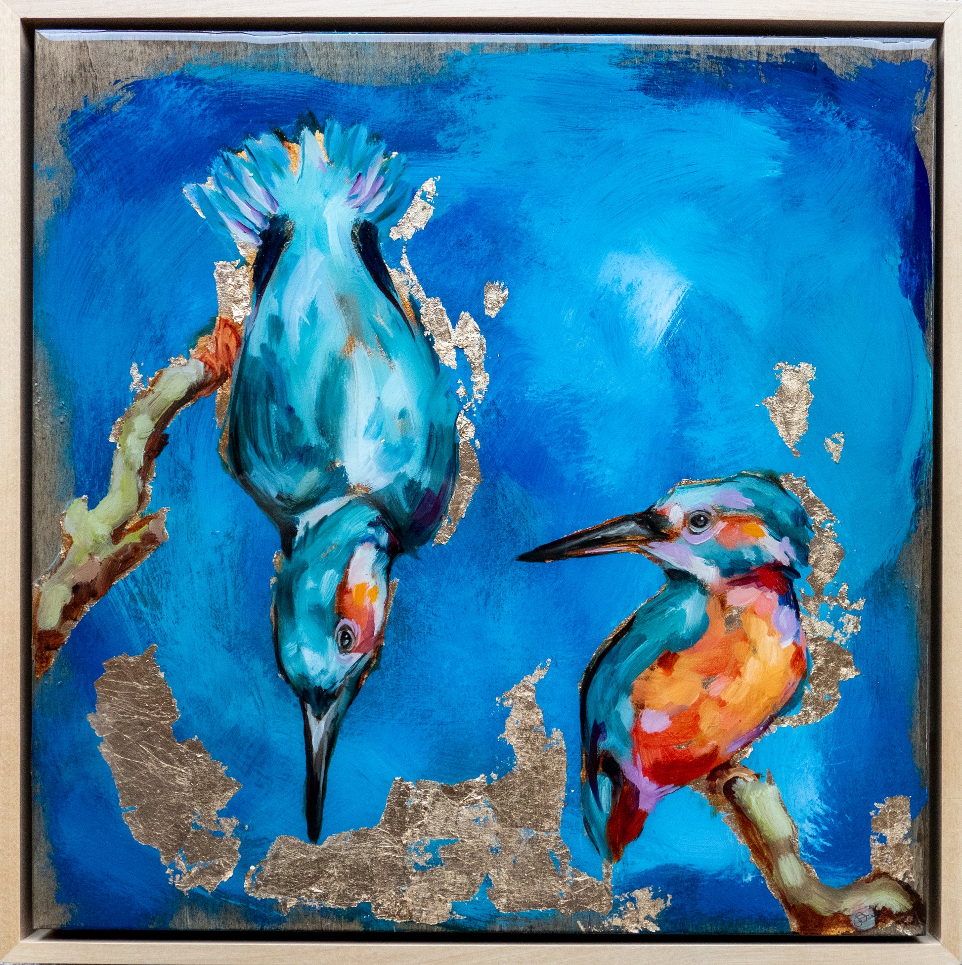 12.5"x12.5" painting of two Kingfishers is mixed media; using acrylic and oil, pencil, and gold leaf with glossy resin finish on surface; colorful with mostly blues and golds; artist Shaney Watters;  incl raw maple float frame