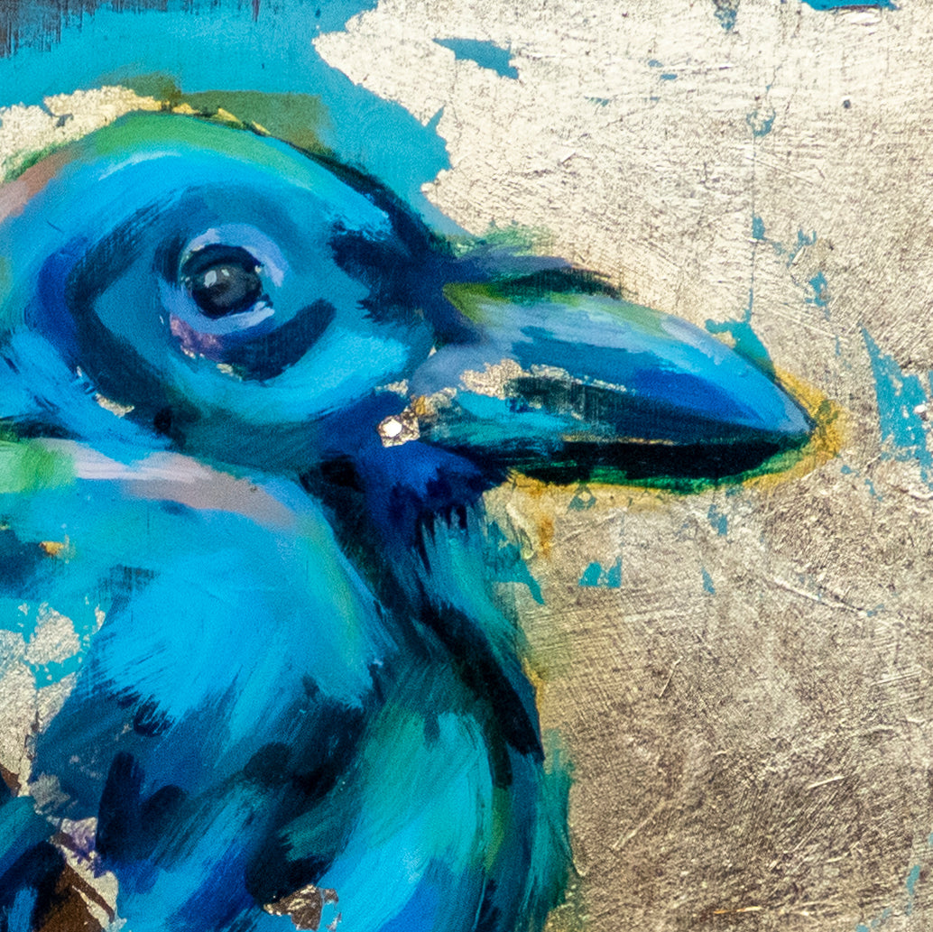 Close up of  painting of Raven using mixed media; acrylic and oil, pencil, and gold leaf with glossy resin finish on surface; shades of blue and gold; artist Shaney Watters