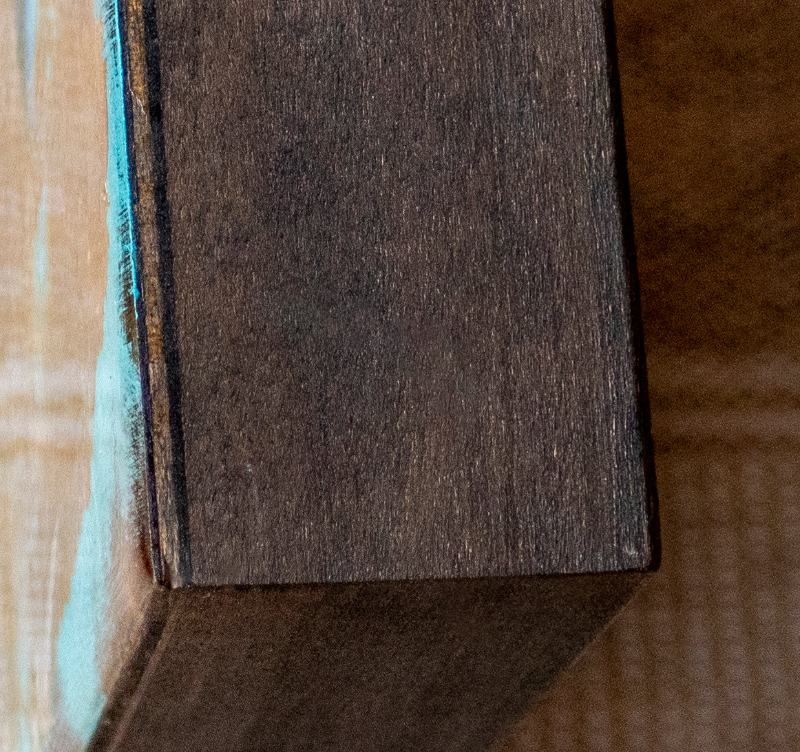 Image of side of wood cradle board used for painting of Raven; artist Shaney Watters